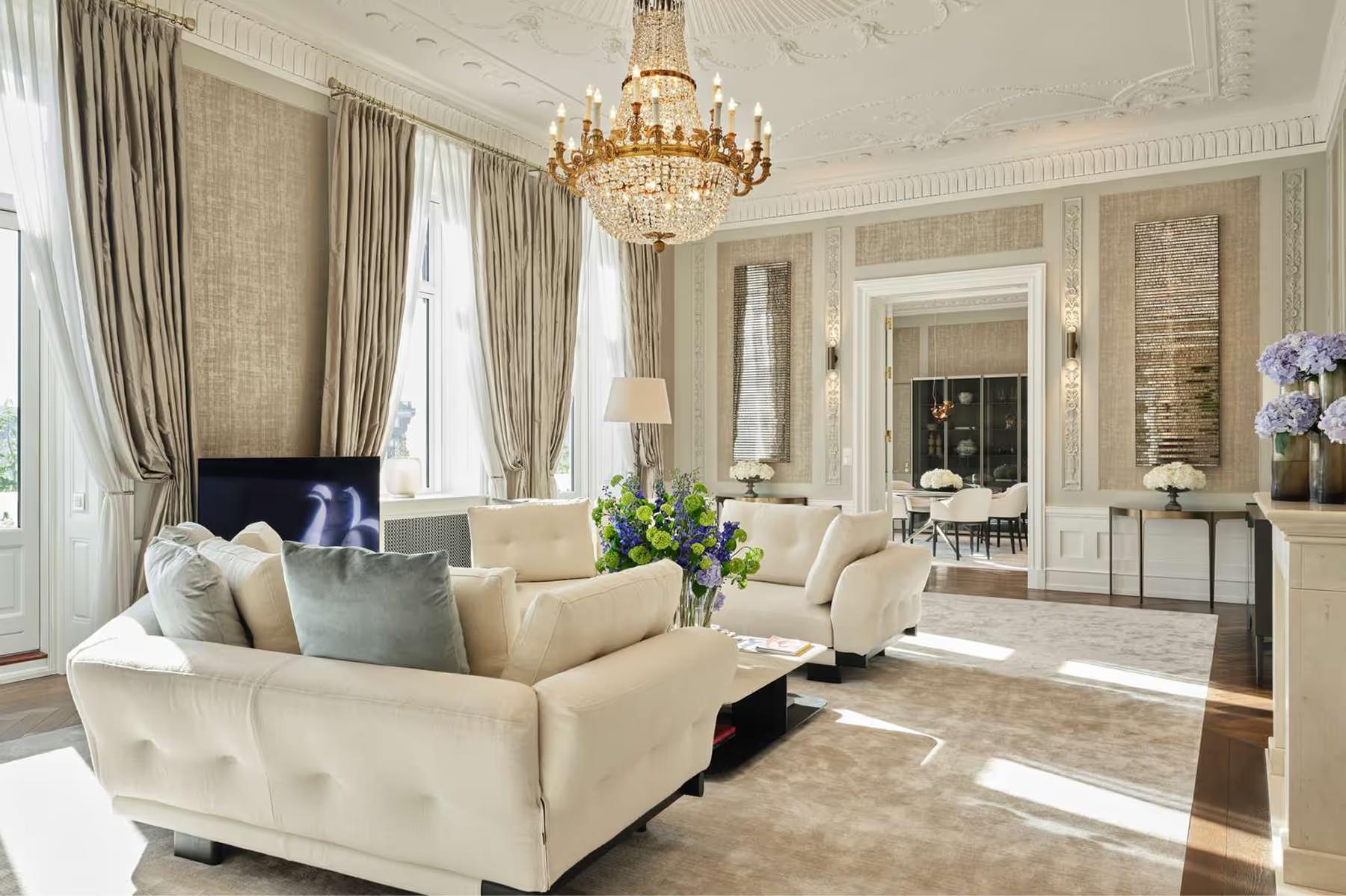 Hotel d’Angleterre: suite with pale furniture, arched mirrors and soft natural light