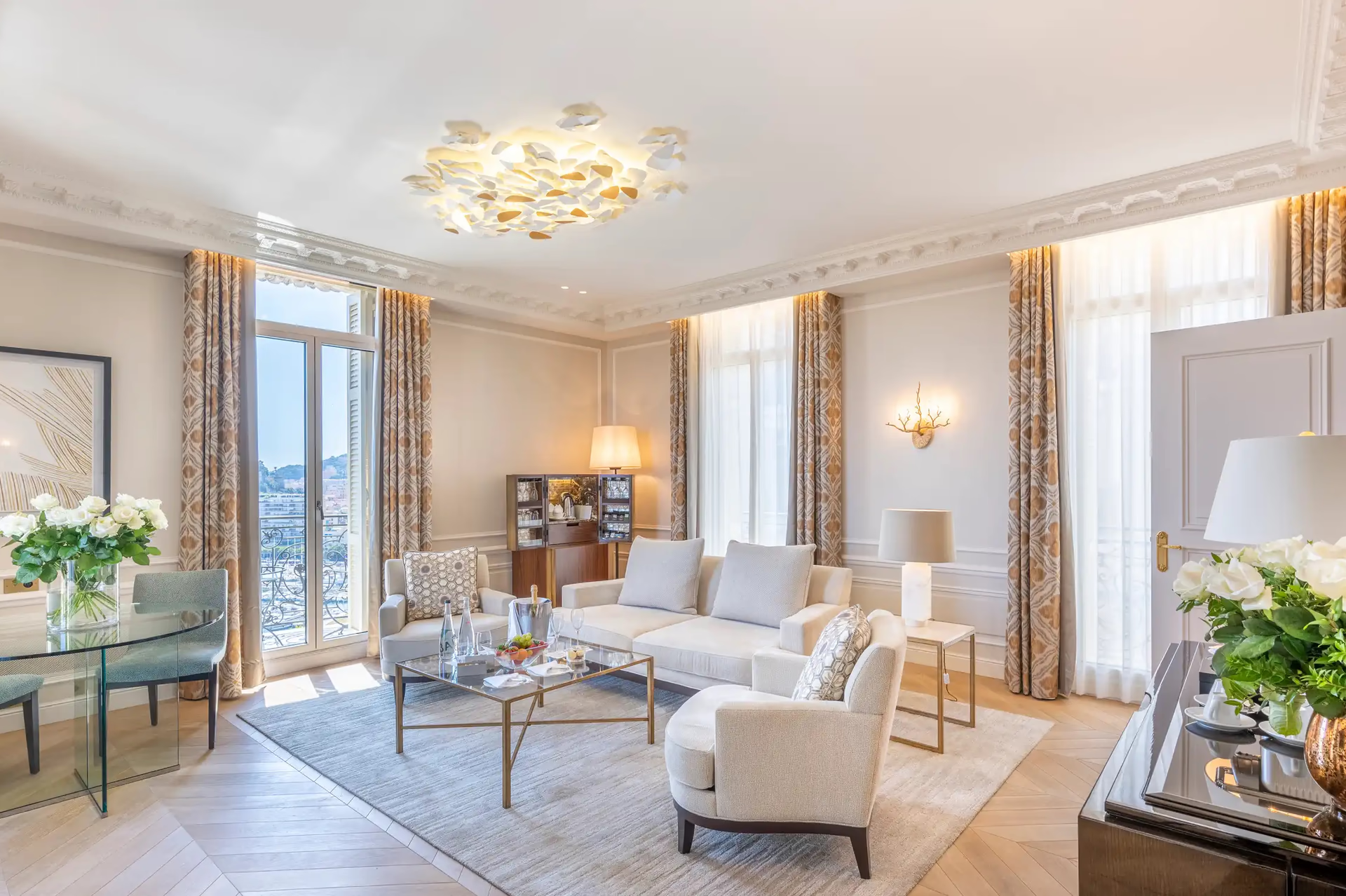 Hôtel Hermitage Monte-Carlo: suite living room with blue drapes, sofa seating and arched doors opening to terrace view