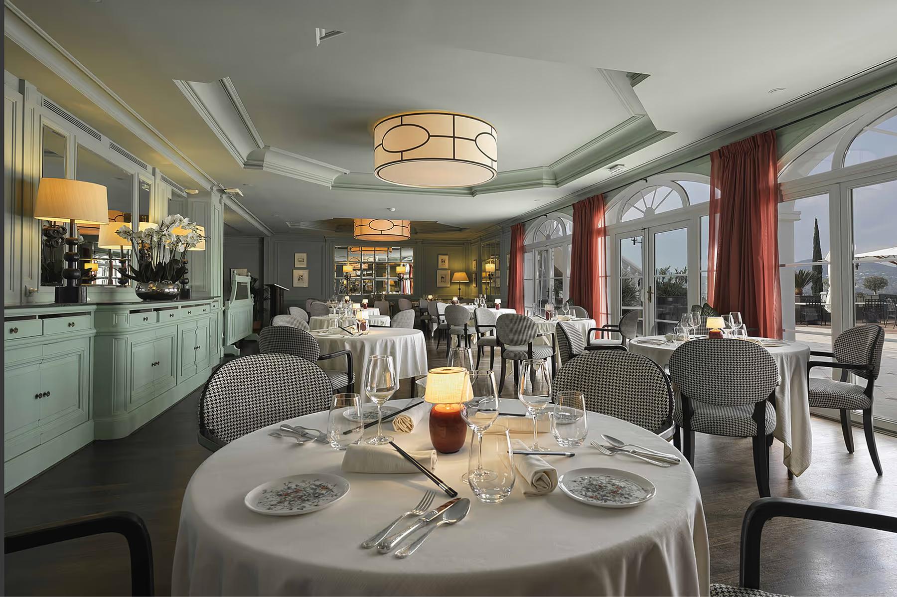 Althoff Villa Belrose: fine dining room with round table set with white linens and sea-view doors