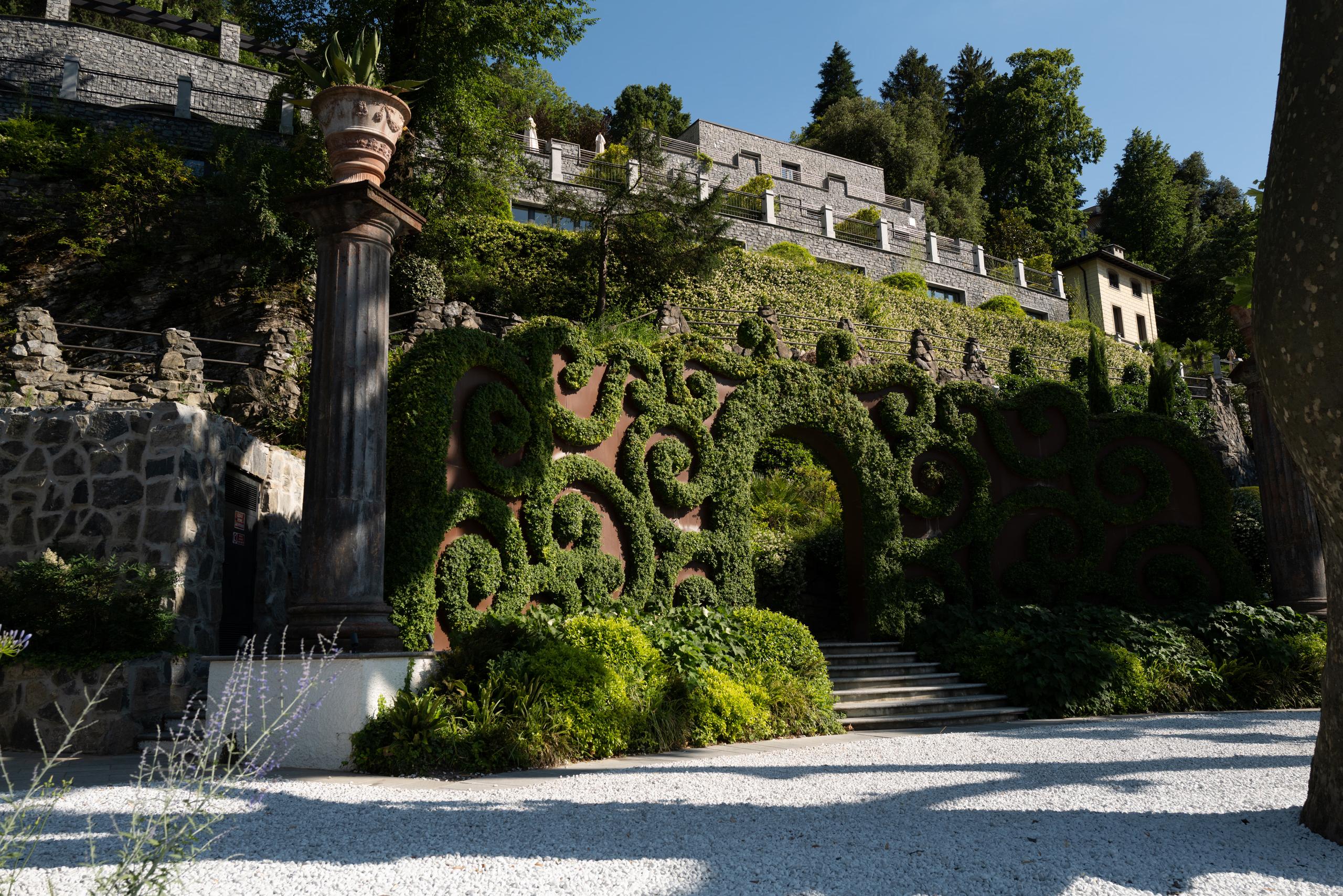 Mandarin Oriental, Lake Como: stacked villas on a green hillside with stone architecture and manicured landscaping