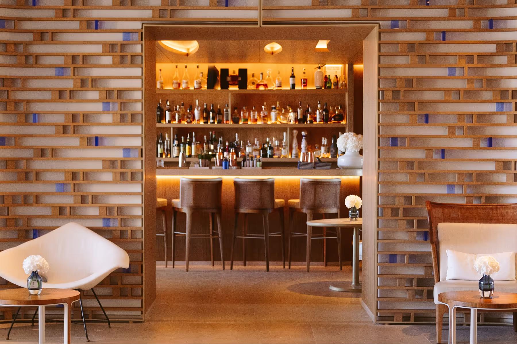 Brick bar entrance with backlit bottles and warm lighting