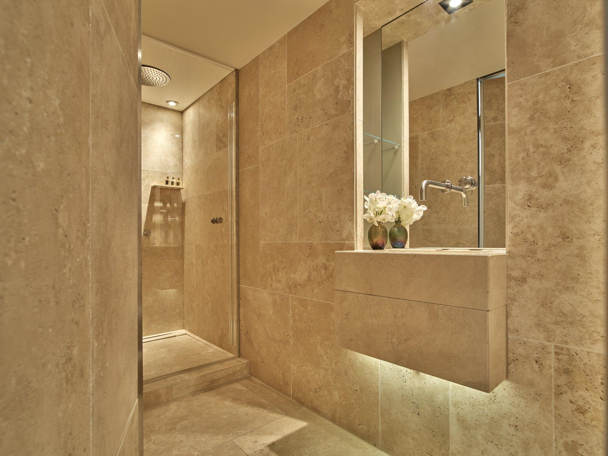 Mandarin Oriental Conservatorium, Amsterdam: modern marble spa bathroom with walk-in shower, built-in wall niche, and soft lighting