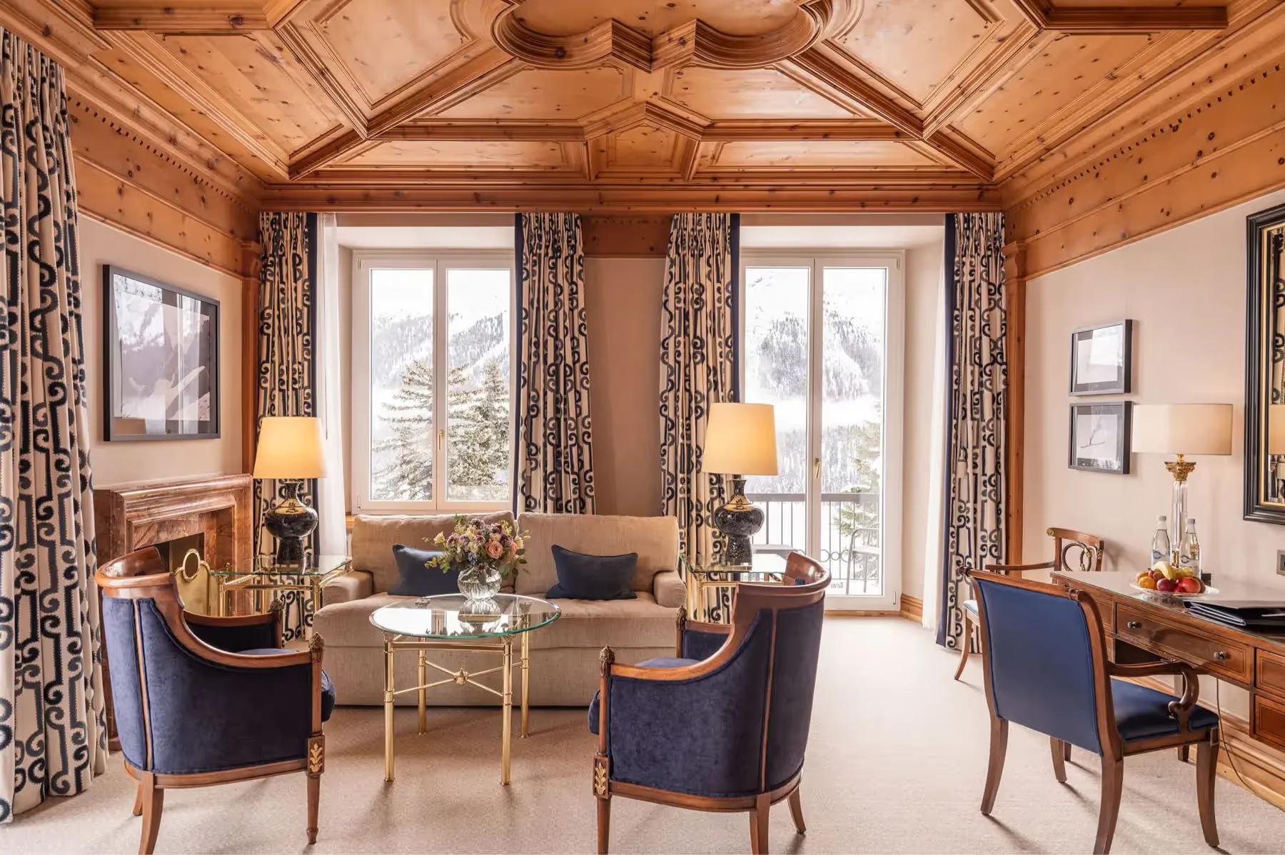 Kulm Hotel St. Moritz: a living room with wood architecture, fireplace, and contemporary furnishings