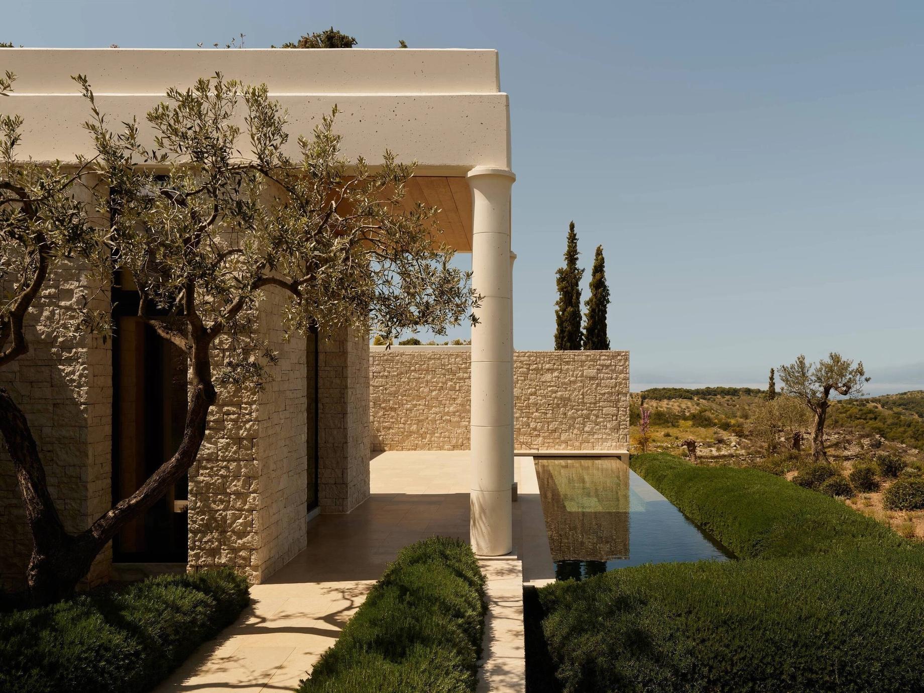 A honey-stone villa beside a still pool at Porto Heli