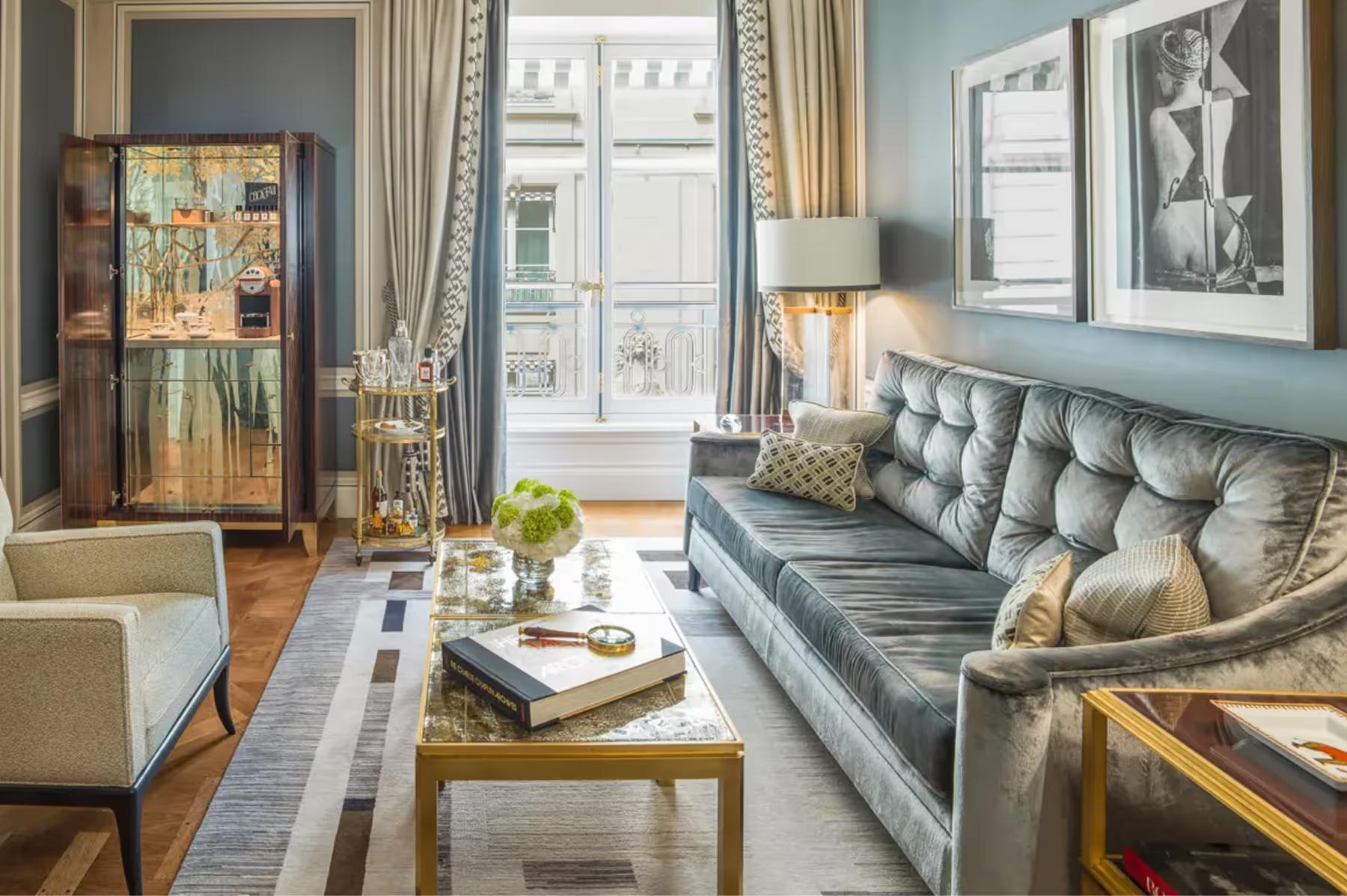 Hôtel de Crillon: suite with blue upholstered sofa, tall windows, and classical furnishings