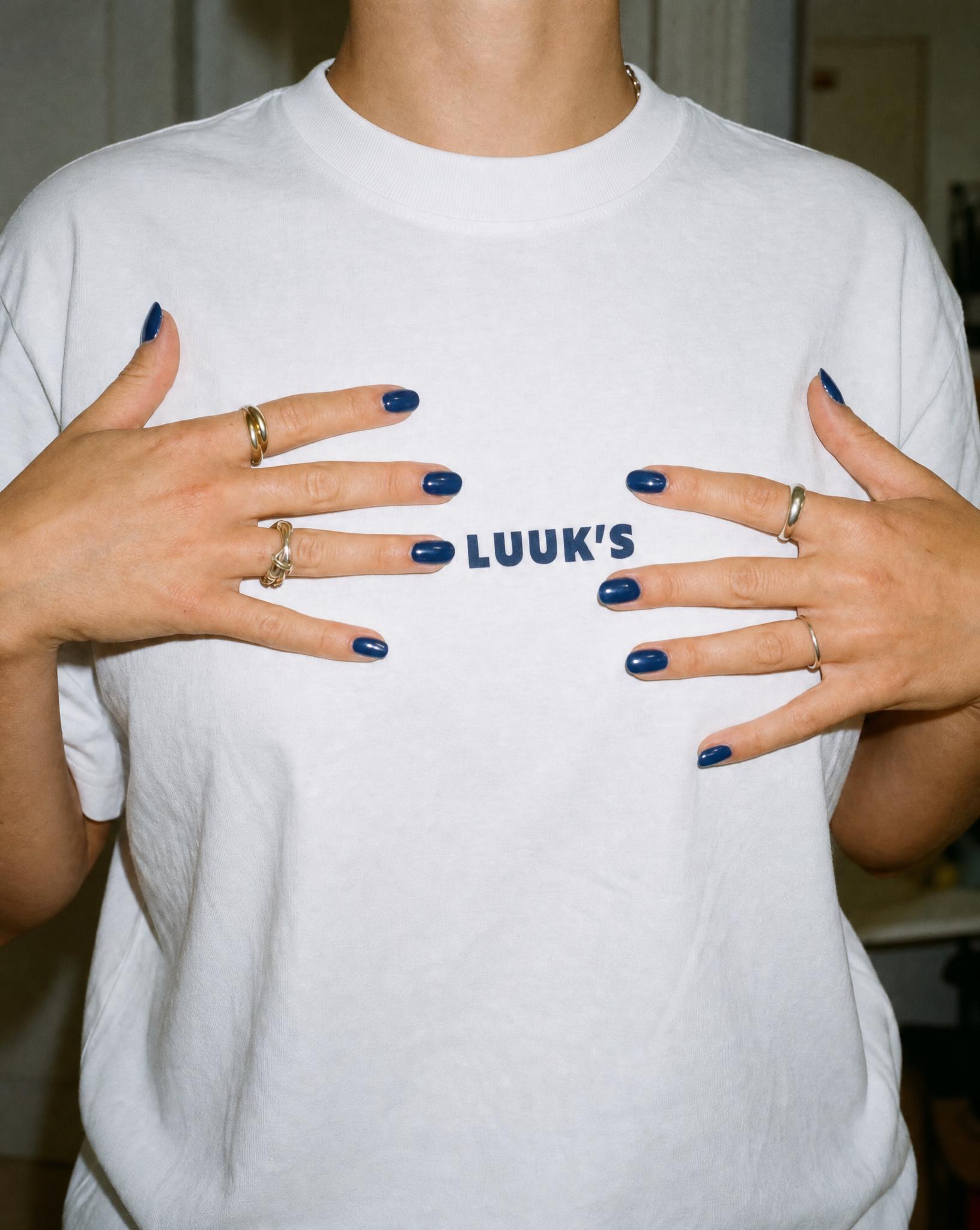 A staff t-shirt with the Luuk’s wordmark