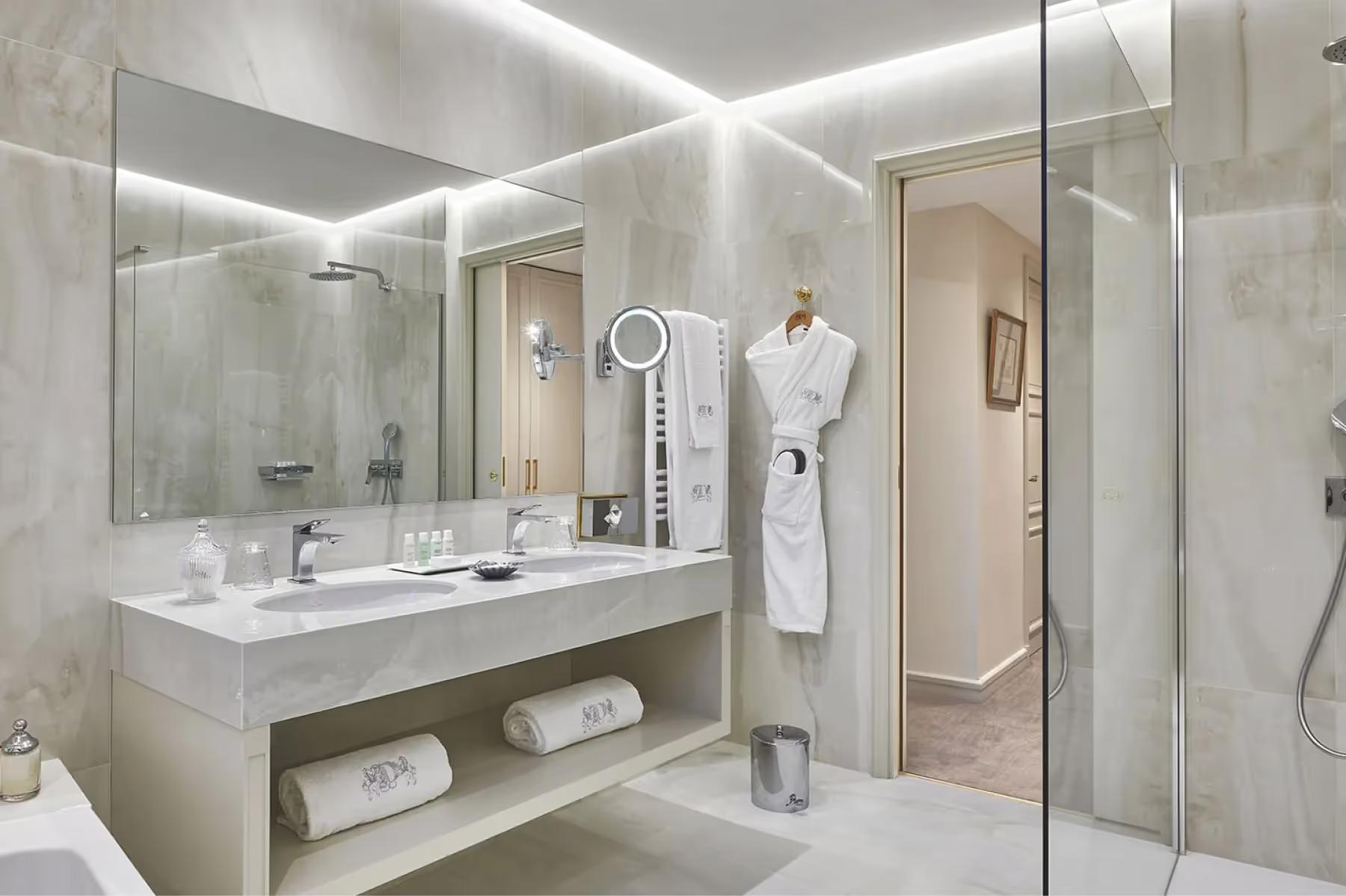 Bathroom with floating vanity, large mirror, and modern fixtures