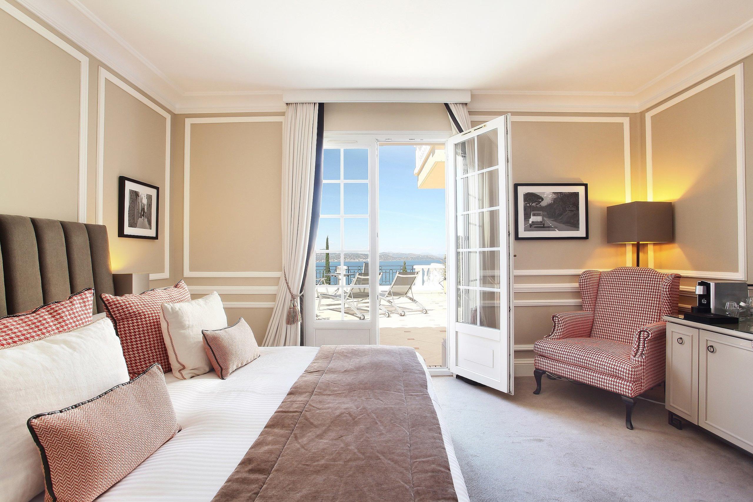 Althoff Villa Belrose: suite with upholstered reading chair beside floor-to-ceiling windows