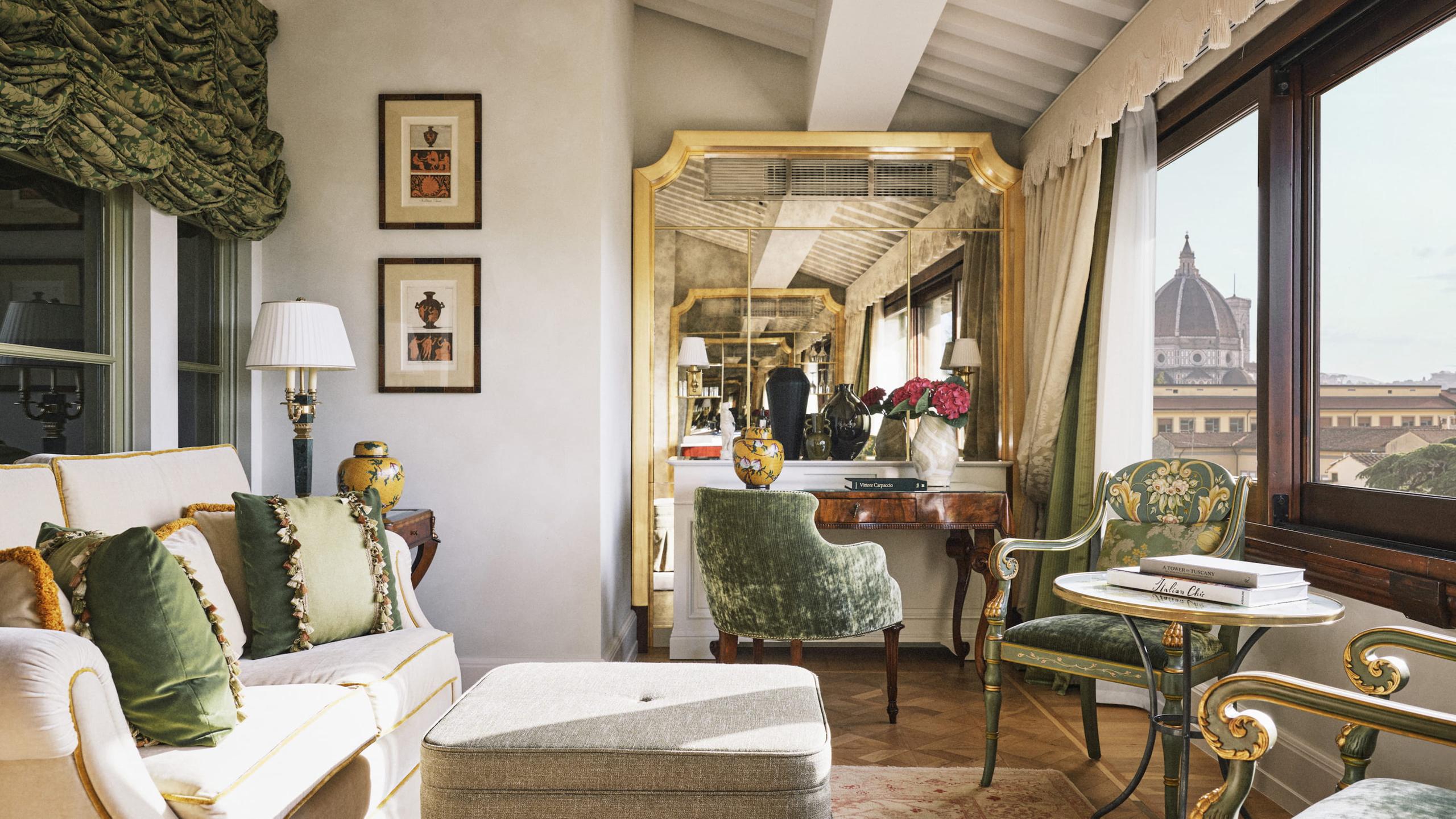 Four Seasons Hotel Firenze: suite interior with cream walls, gallery views of the Duomo through tall windows, and classical furnishings