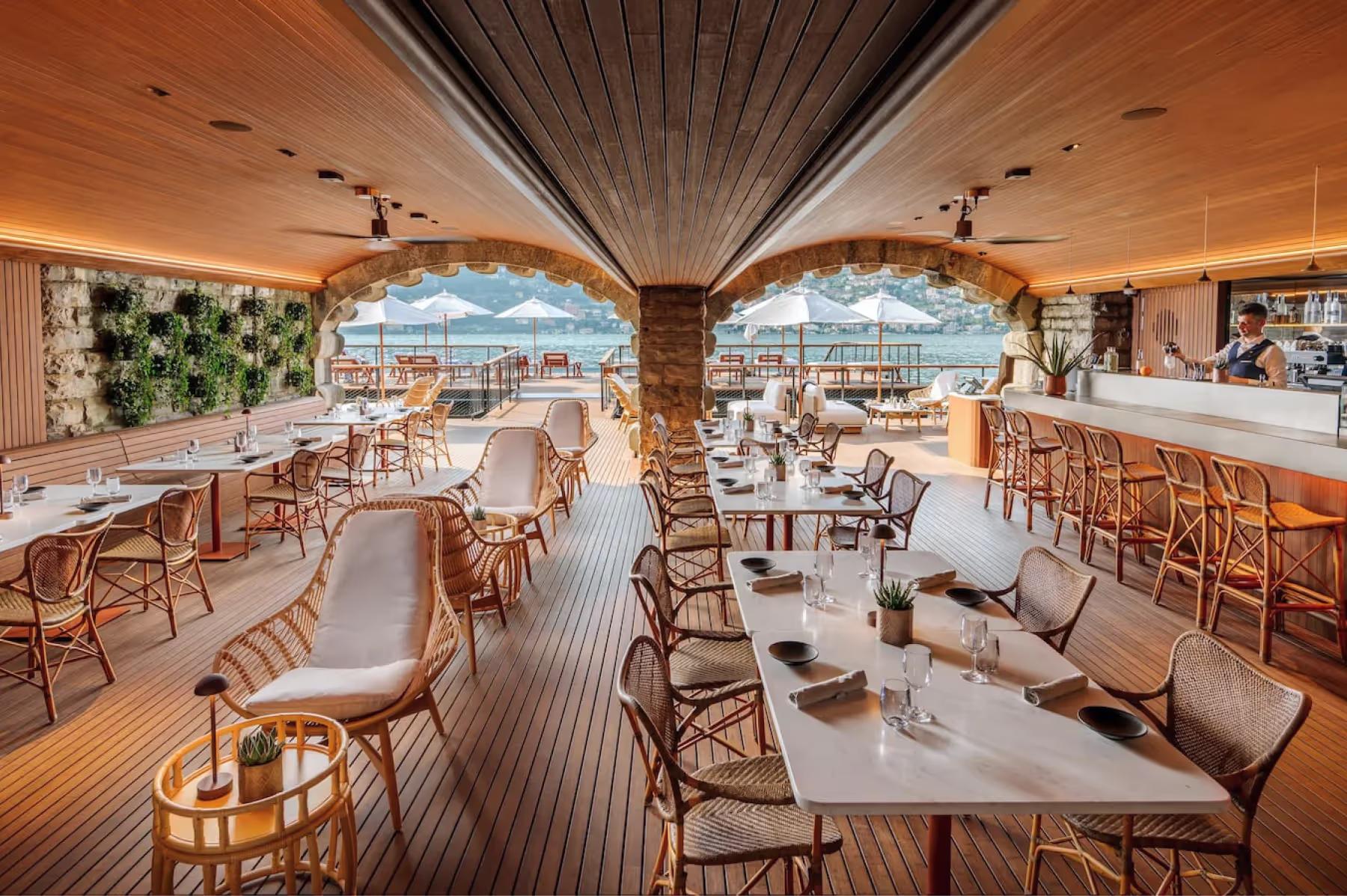 Mandarin Oriental, Lake Como: modern dining pavilion with white linens, wooden furnishings, and panoramic lake views