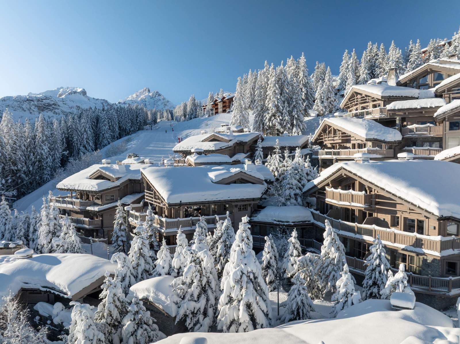 The chalets of Le K2 Palace cascading down a snowy hillside in Courchevel