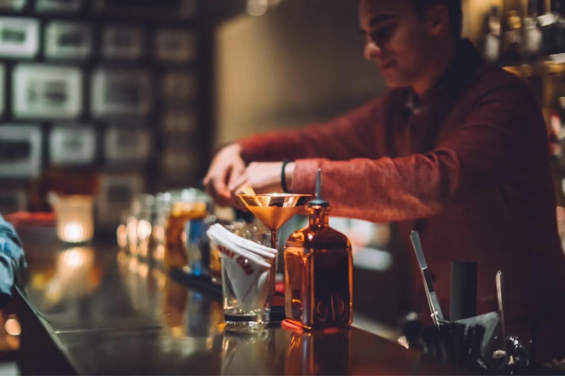 The bar area with warm wood tones and glasses displayed for cocktail service