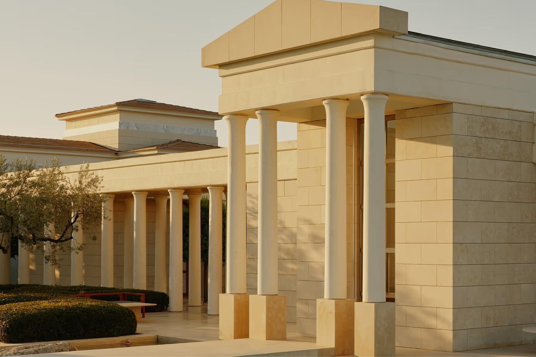 Stone villa exterior with classical pillar details at sunset