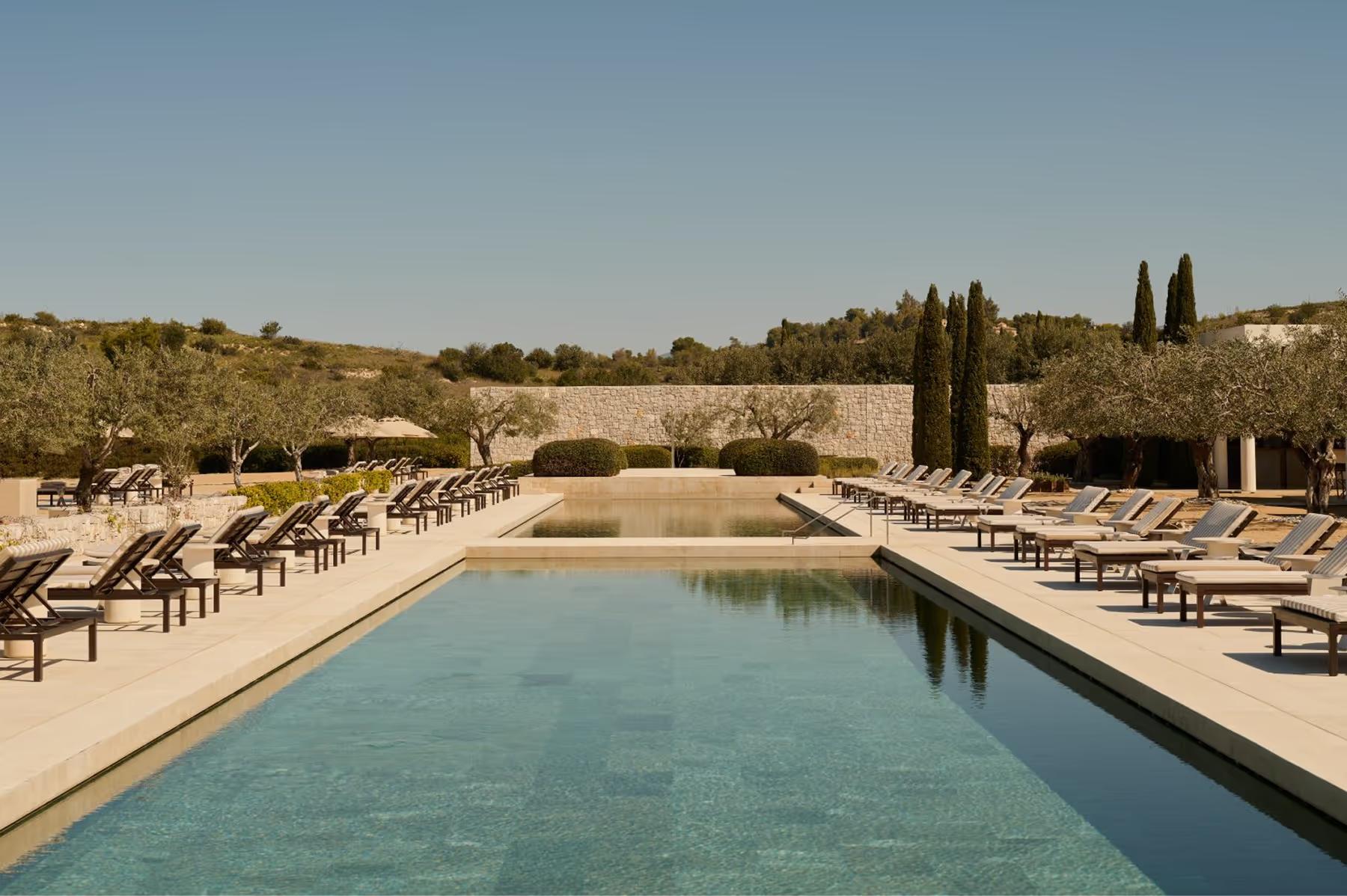 Amanzoe: columned waterfront structure with illuminated facade at dusk
