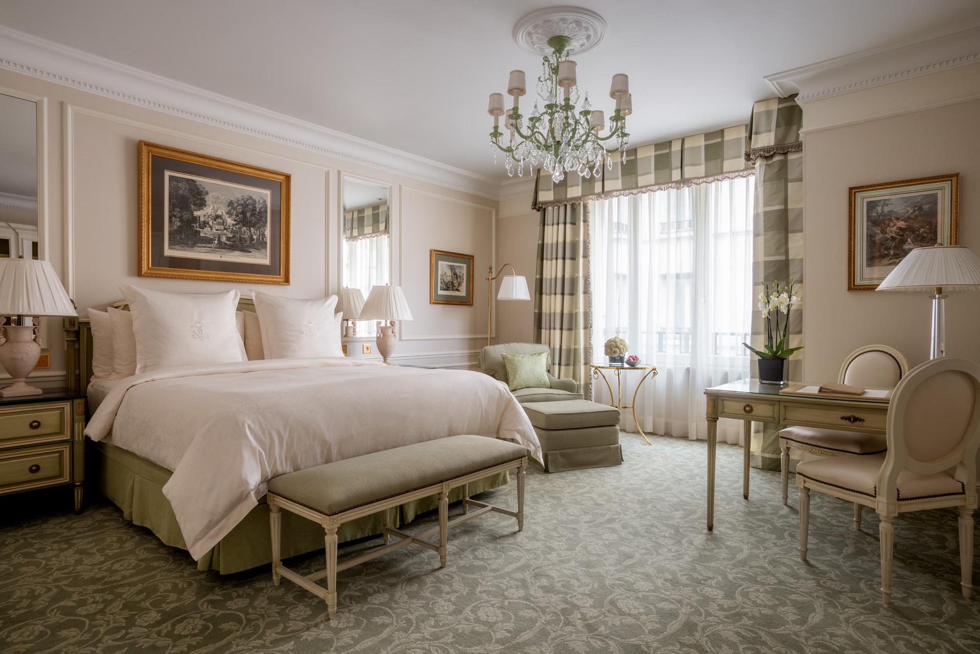 Four Seasons Hotel George V: a classical bedroom with gilt accents, arched ceiling details, and a chandelier