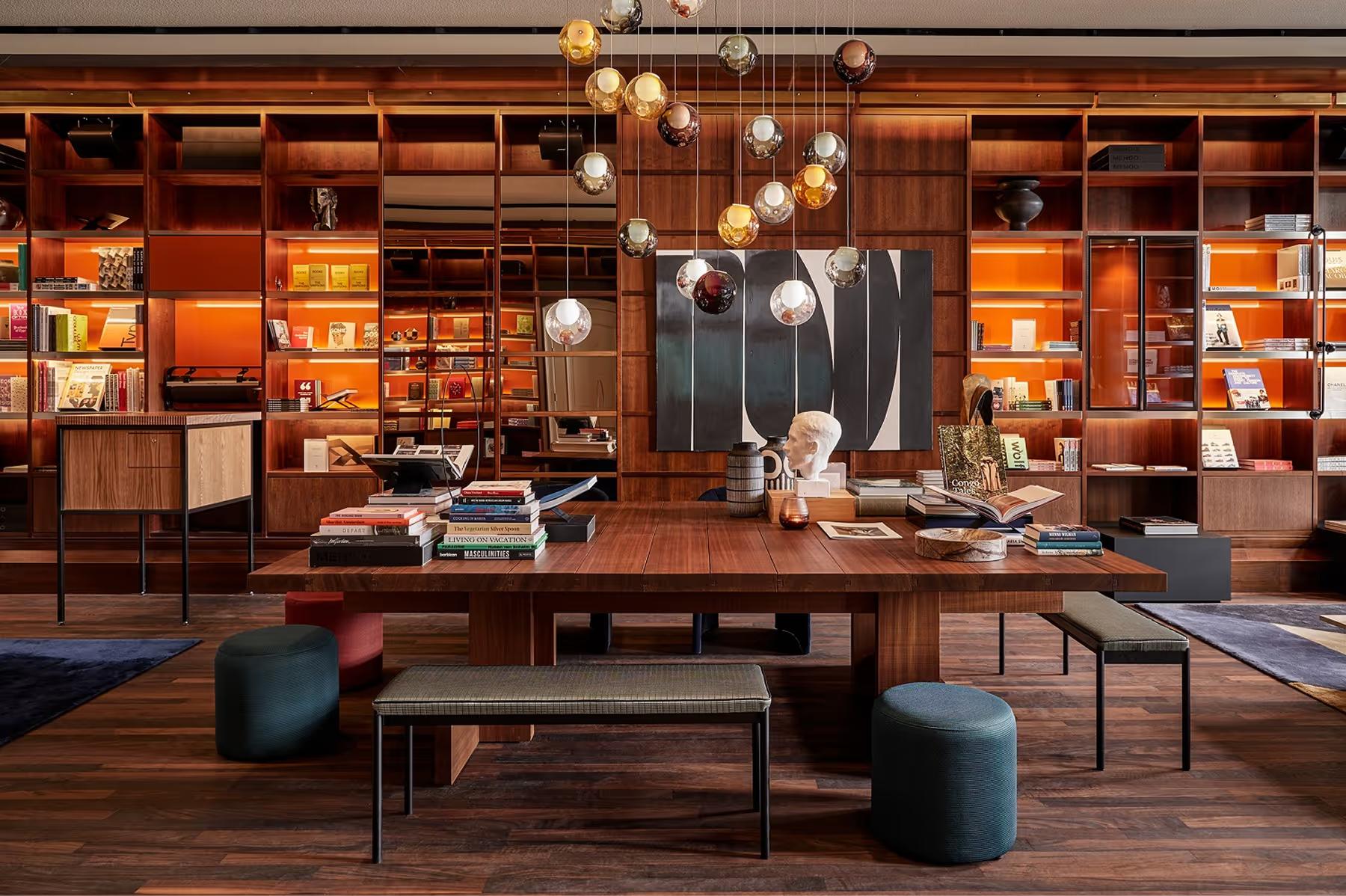 Library wall with extensive book collection, wood shelving, and reading furniture