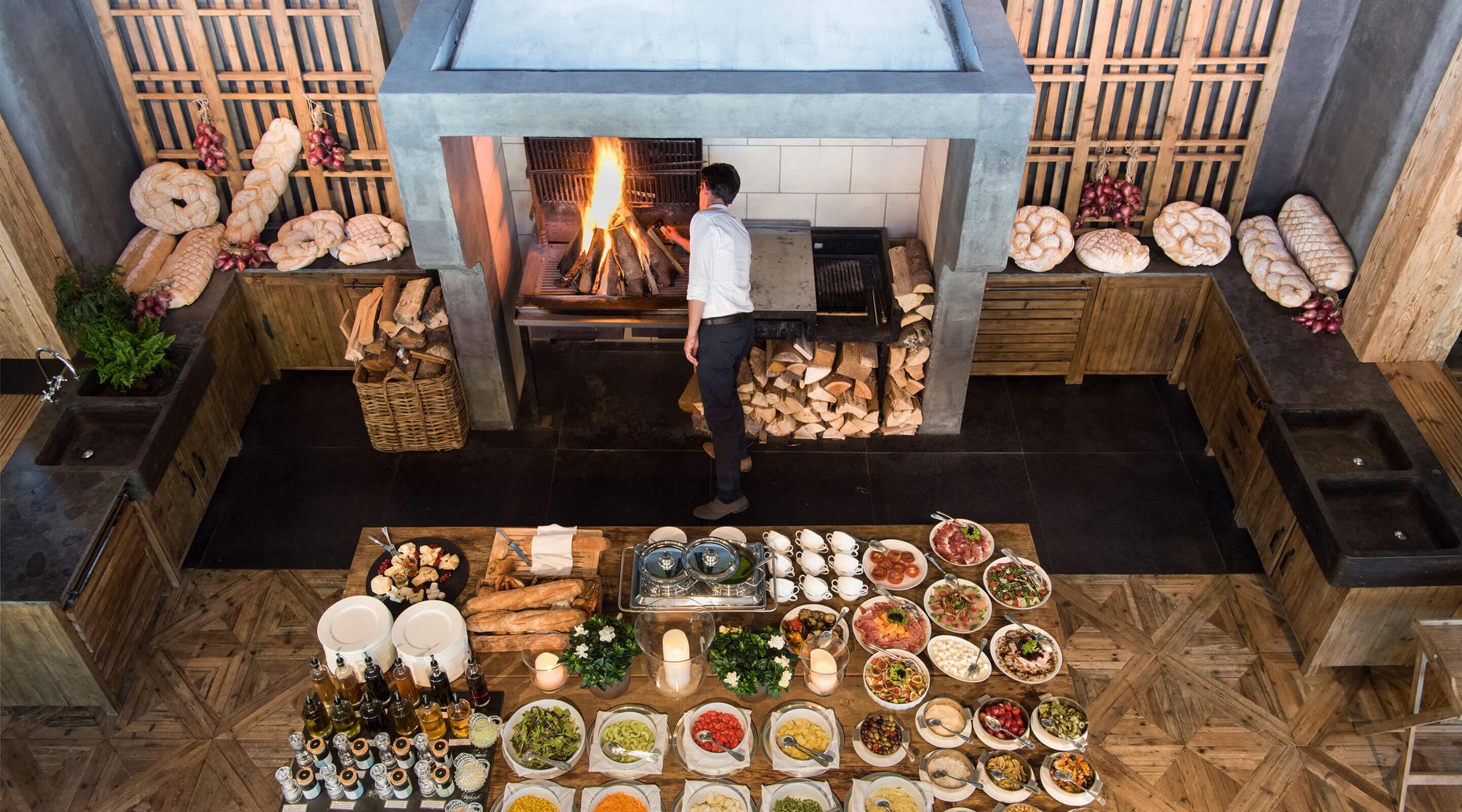 San Luis Retreat: overhead view of a dining area with fireplace and multiple plated courses