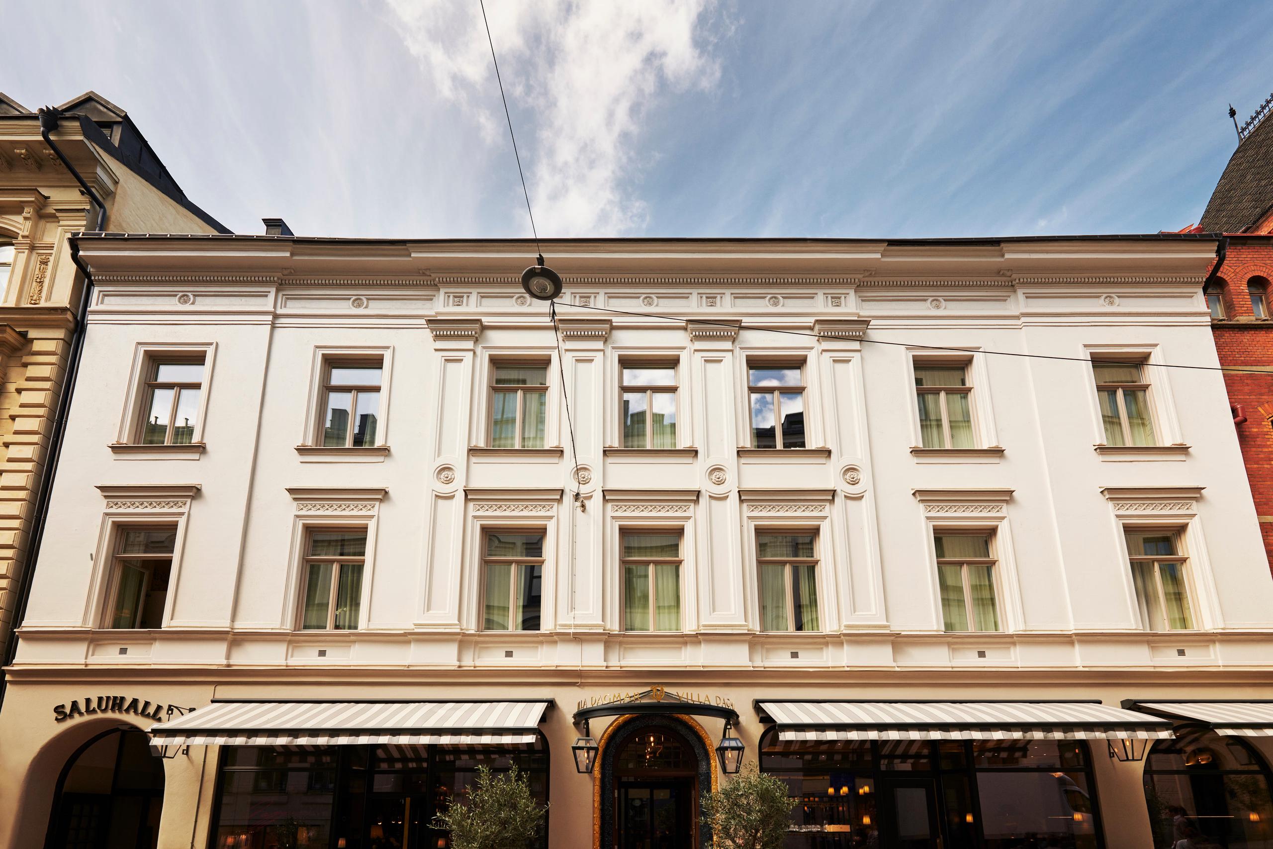 Villa Dagmar: classic European building facade with regular fenestration and ground-floor retail