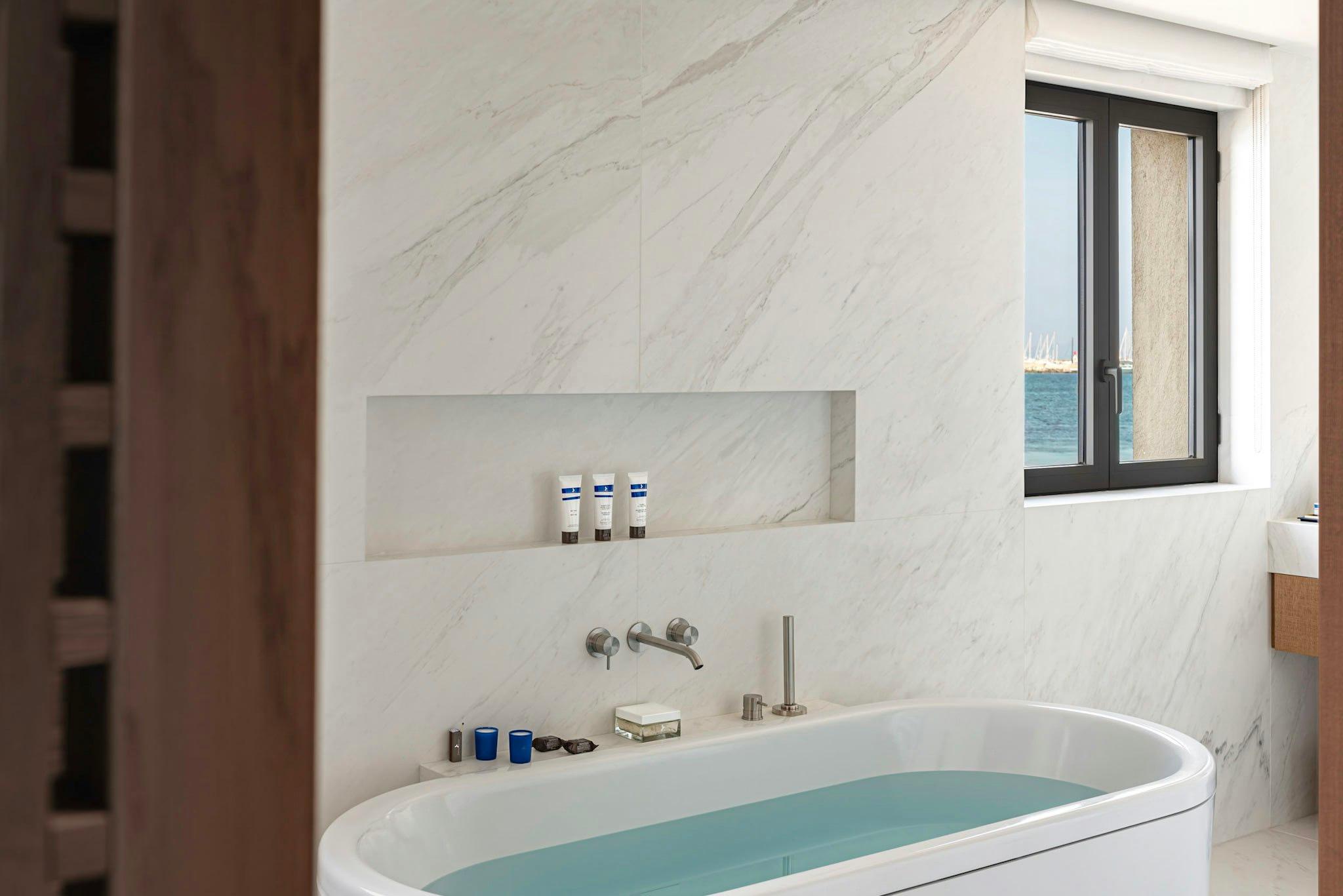 Contemporary bathroom with marble and sea-view window