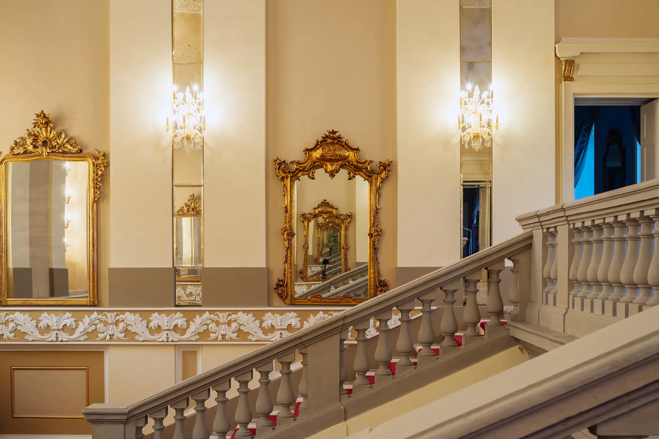 Passalacqua: a foyer with marble staircase, gold railings, and Renaissance architectural details
