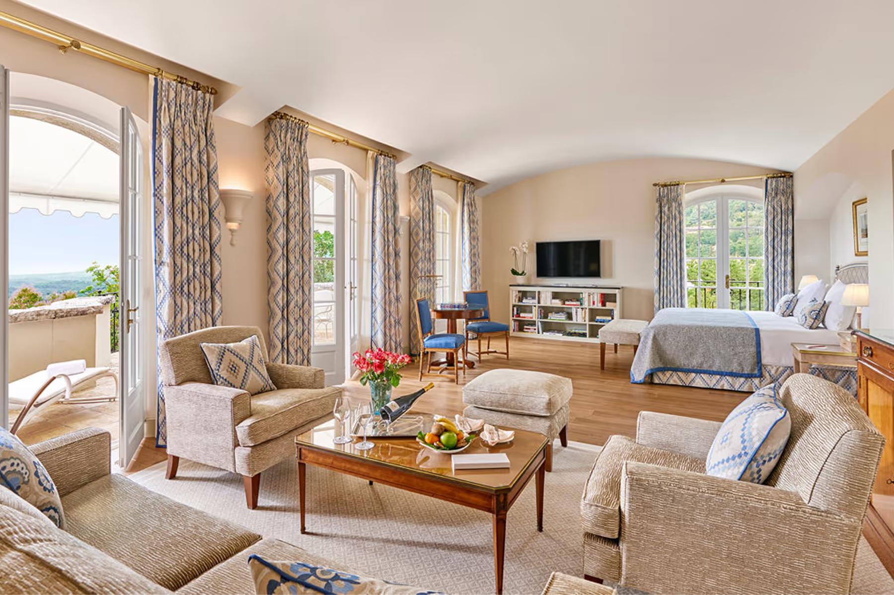 Château Saint Martin & Spa: suite living room with drapes, fireplace, and panoramic windows