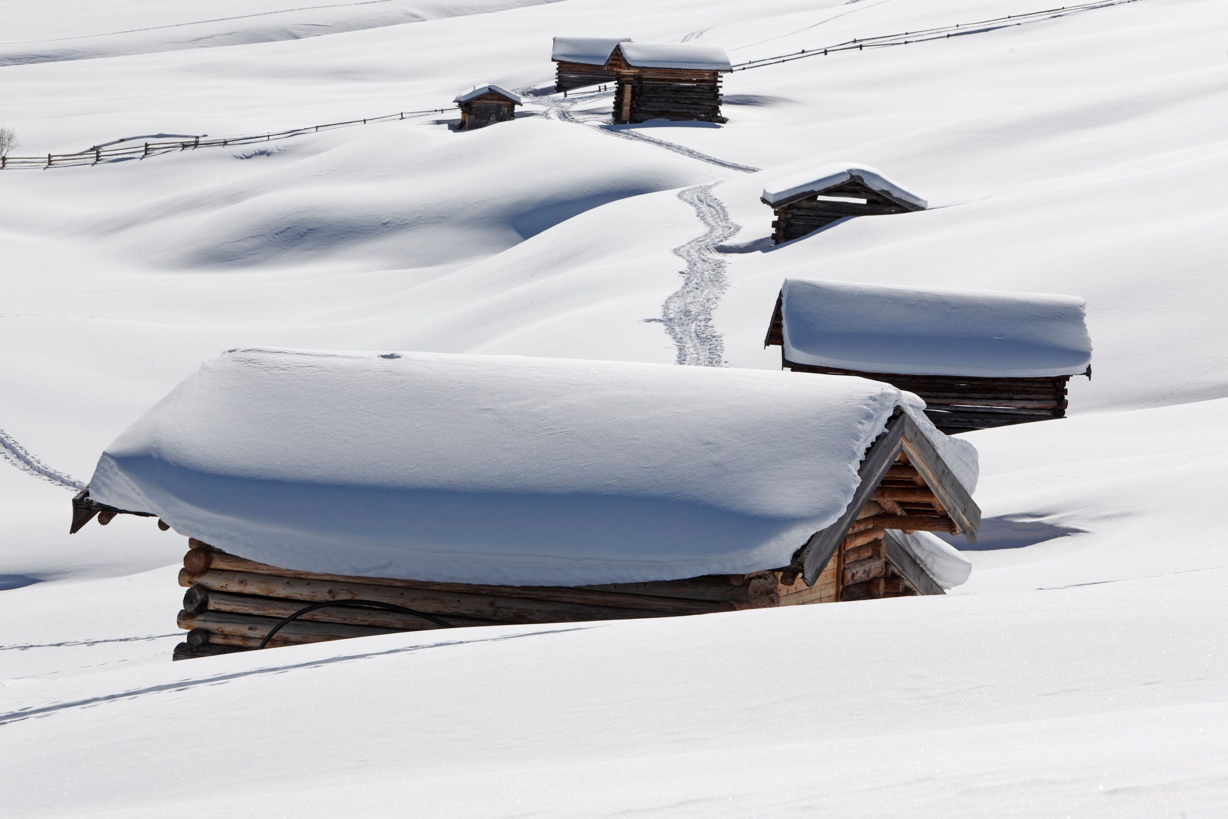 Wooden huts buried in deep snow outside Cortina d’Ampezzo