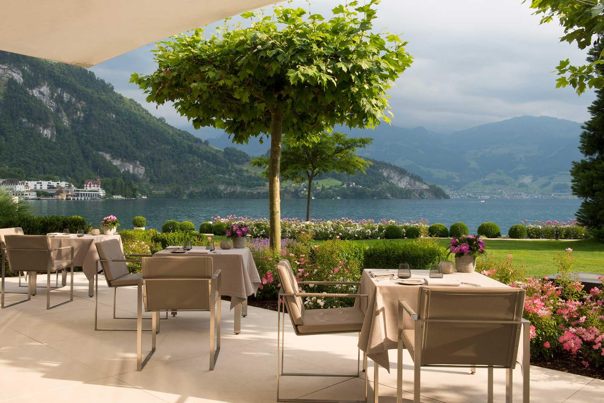 Landscaped terrace with valley views and dining chairs under an umbrella