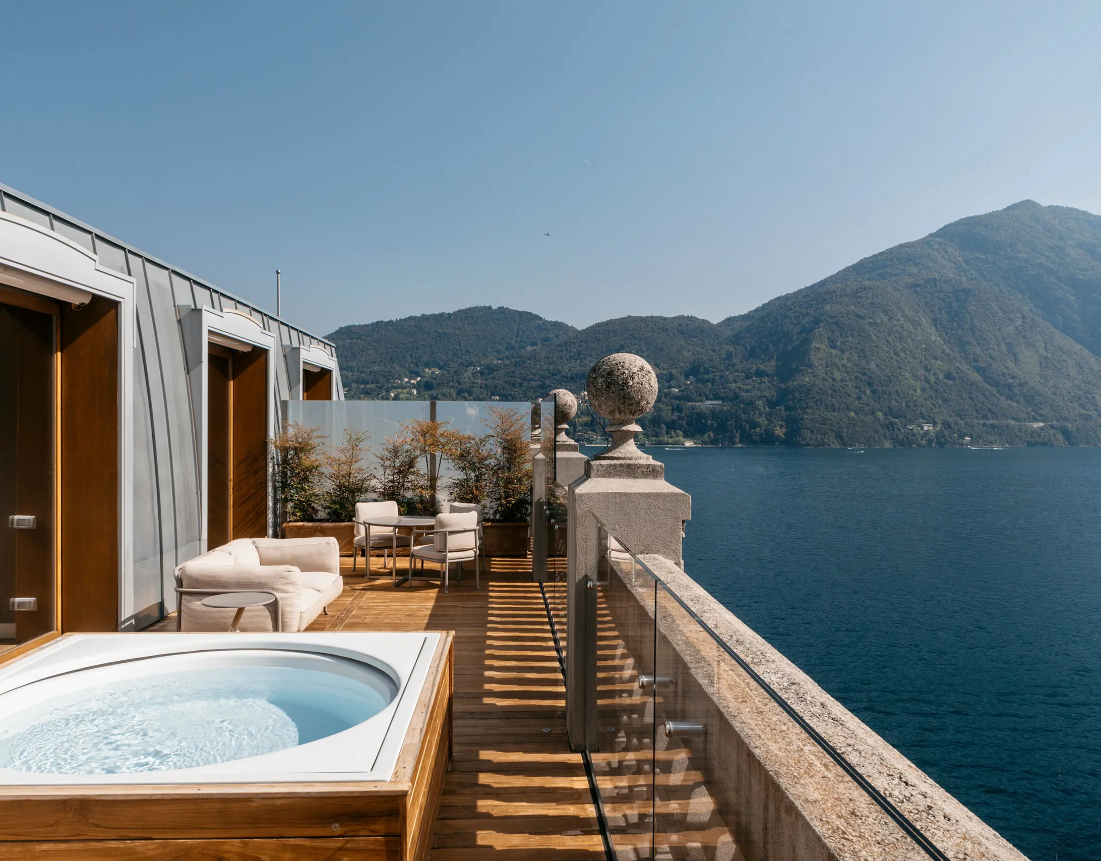 Grand Hotel Tremezzo: waterfront suite terrace with hot tub and lake panorama at dusk