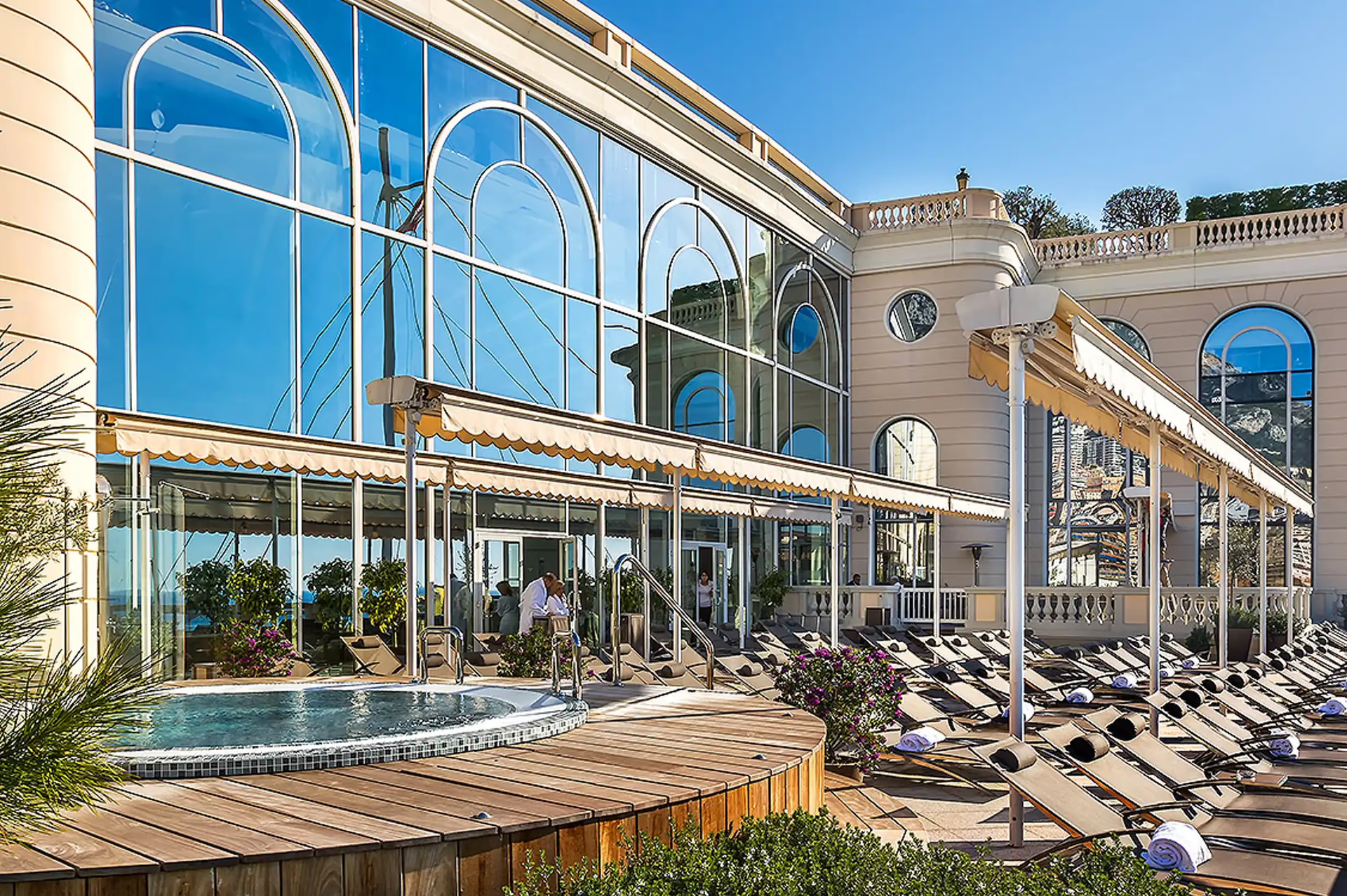 Hôtel de Paris Monte-Carlo: spa facility with indoor pool, tall windows, and white wooden lounge chairs