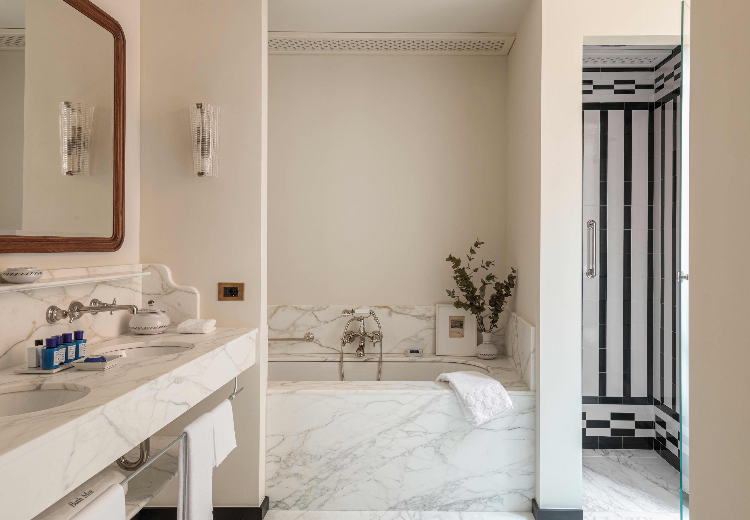 Bathroom with marble sink and black accent wall