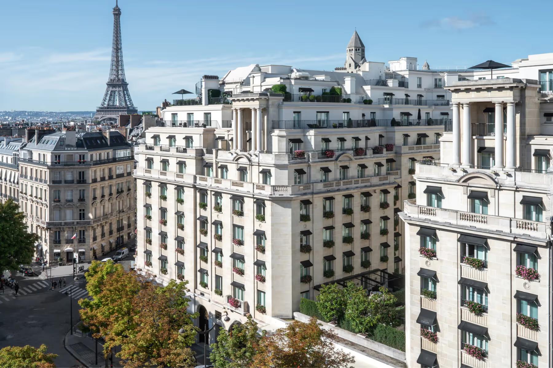 A Parisian rooftop view with the Eiffel Tower visible above the stone buildings