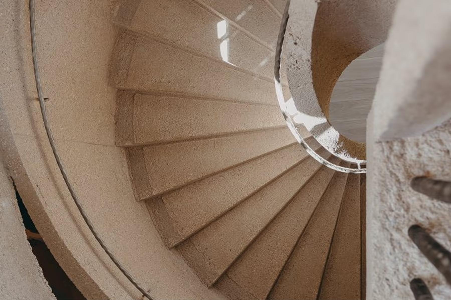 Lily of the Valley: spiral staircase with natural stone and curved metal railing