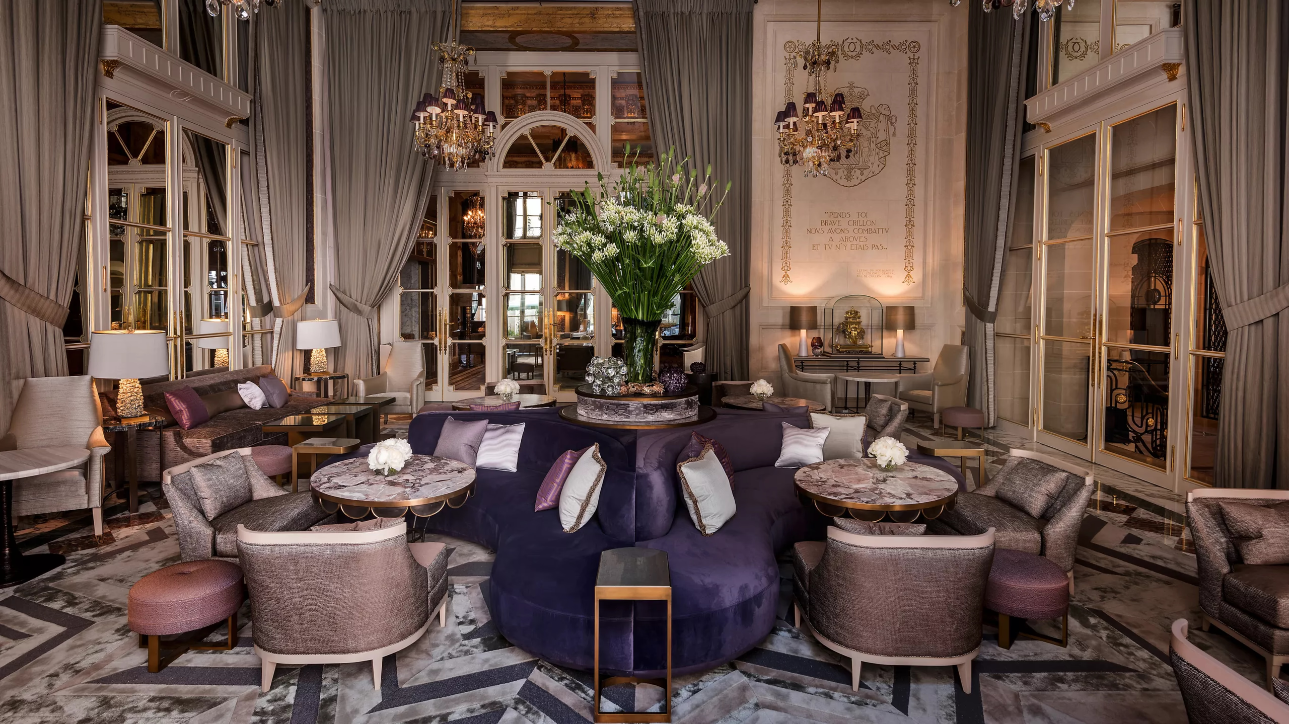 Hôtel de Crillon: formal dining table in dark room with decorative ceiling and candlelit ambiance