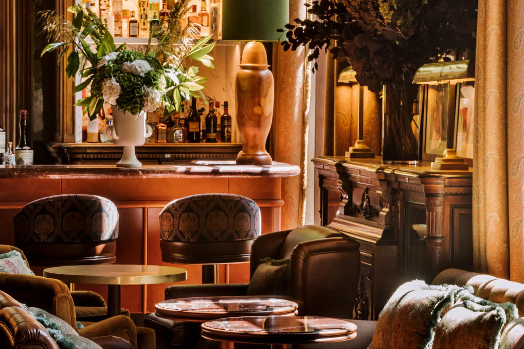 Saint James: garden dining pavilion with climbing ivy, bistro seating, and afternoon sunlight