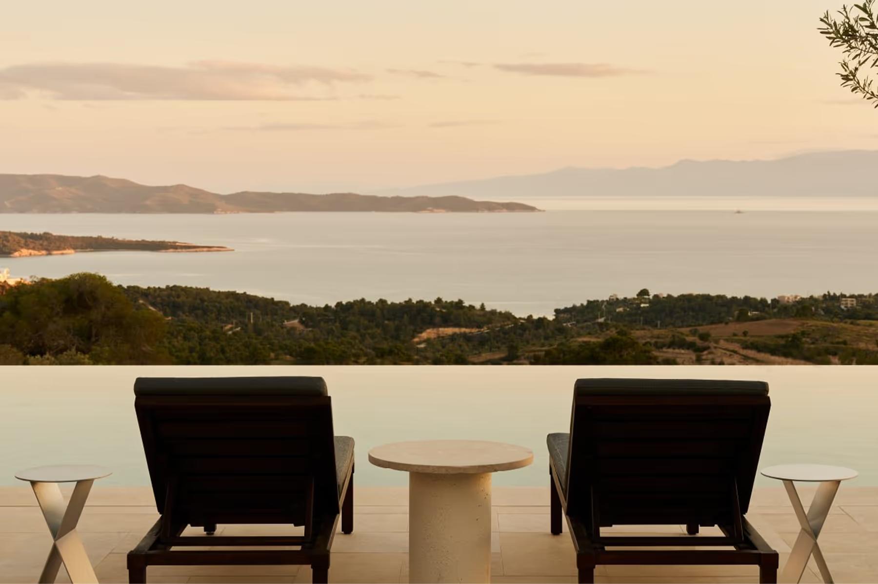 Amanzoe: sheltered pavilion lounge with umbrellas and wraparound sea vistas
