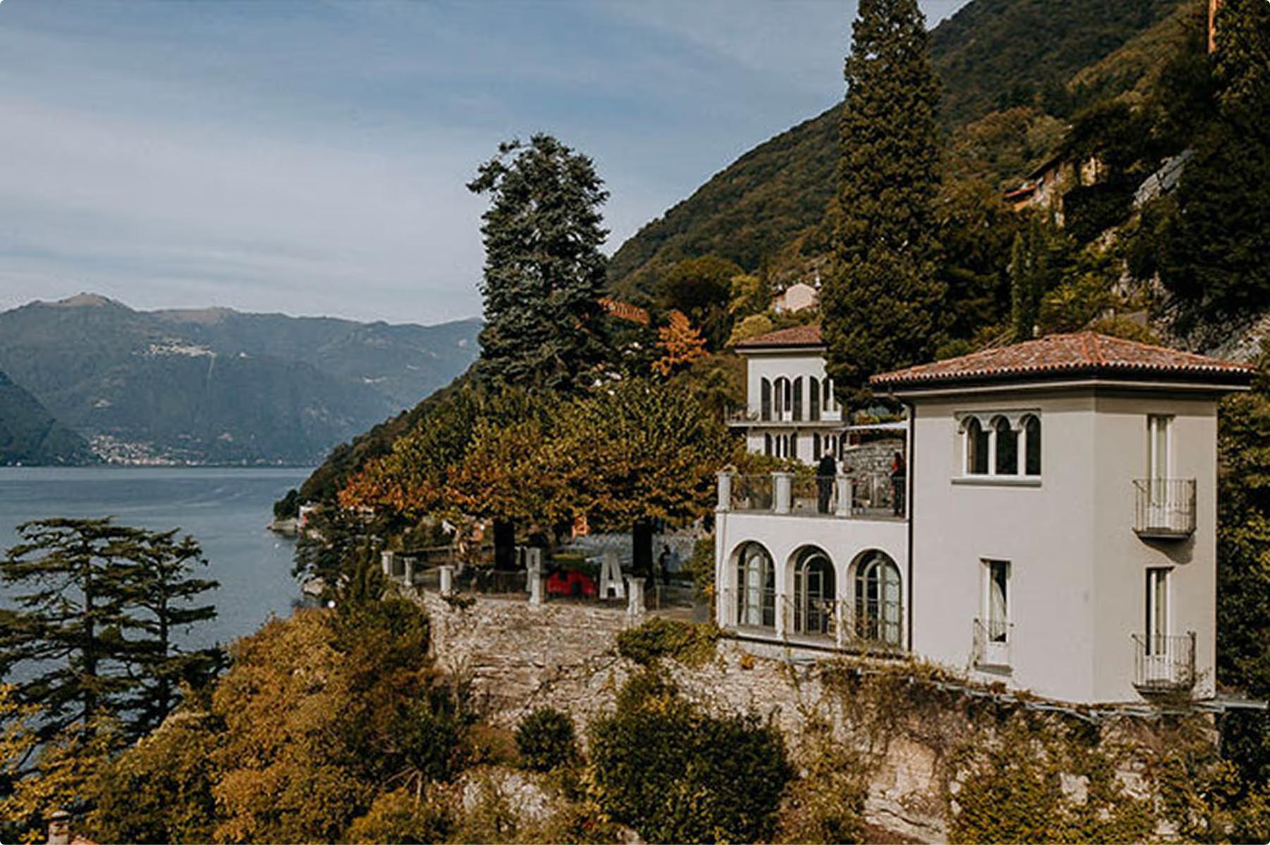 Villa Làrio: historic villa on lakeside bluff with mountain backdrop and autumn foliage
