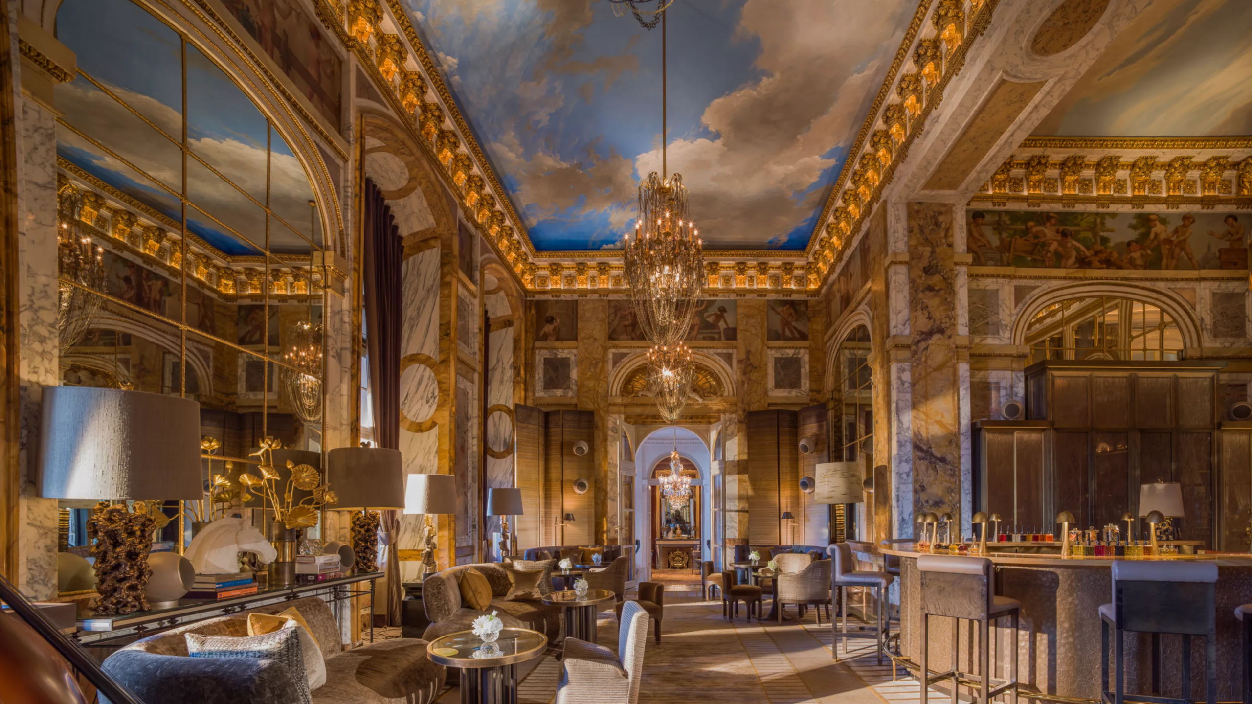 Opulent rococo room with gold ornament, crystal chandelier, and formal table setting