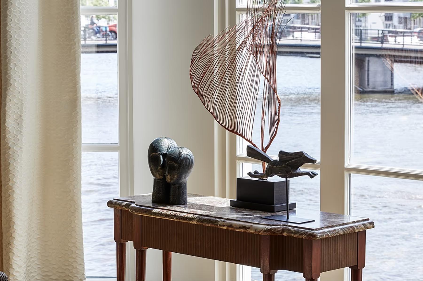 De L’Europe Amsterdam: desk with sculptural arrangement overlooking the Amstel River