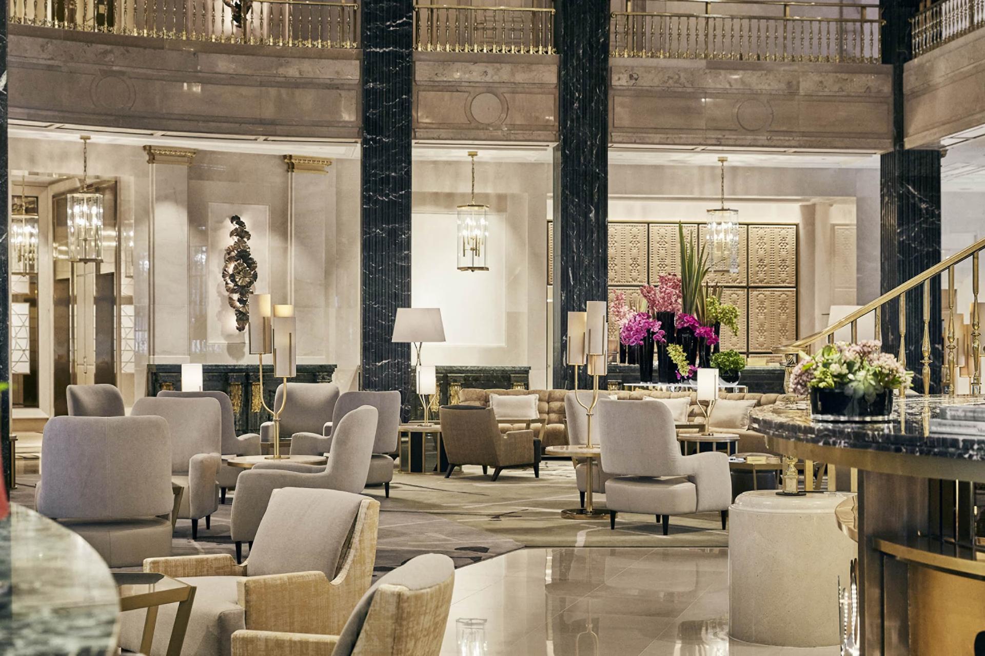 Four Seasons Hotel Madrid: restaurant with tall ceilings, black columns, neutral furnishings, and ornamental wall decor