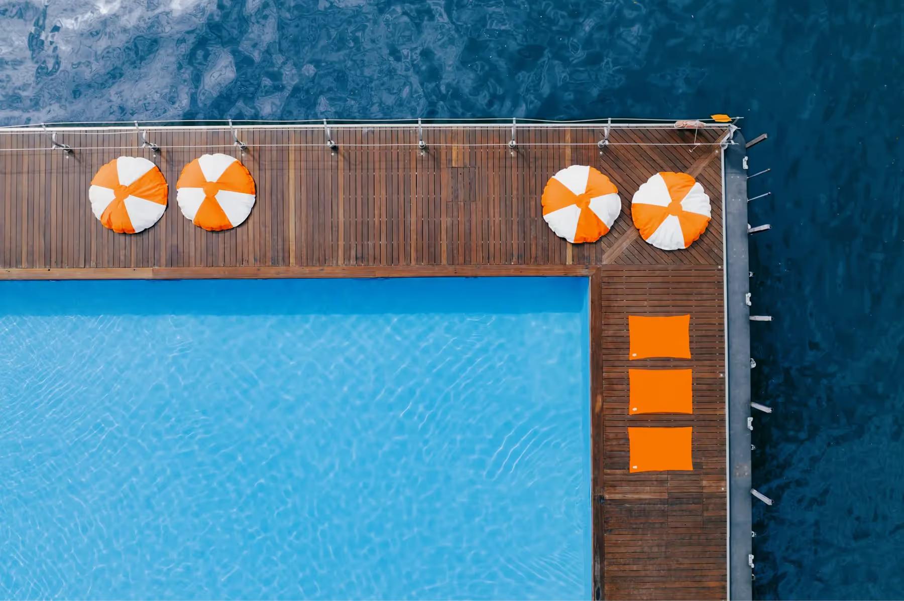 Grand Hotel Tremezzo: pool edge with orange umbrellas and wooden deck overlooking water