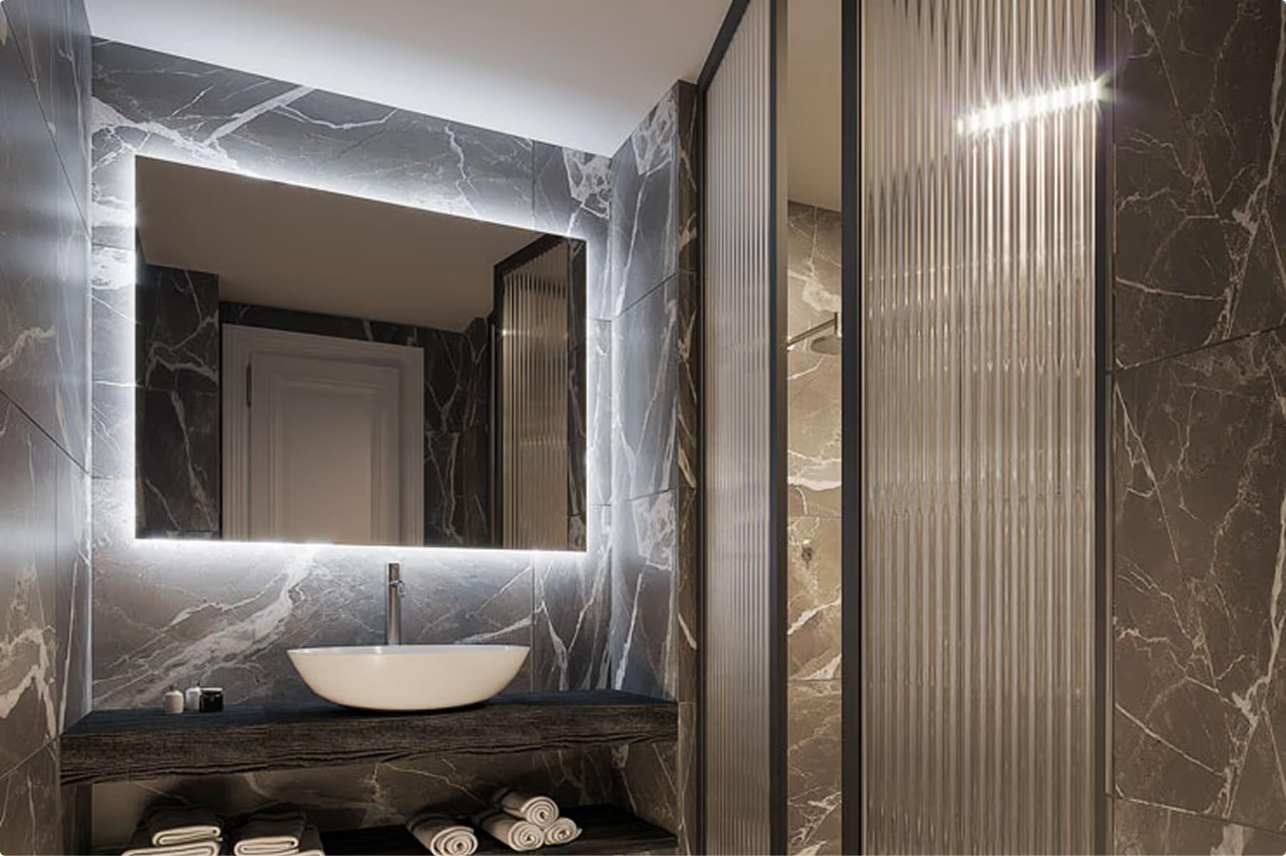 Villa Làrio: marble bathroom with black tile accents and sculptural limestone basin