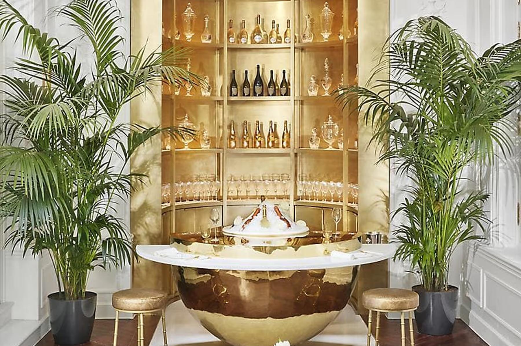 Intimate bar with golden beverage cabinet and palm plant accents