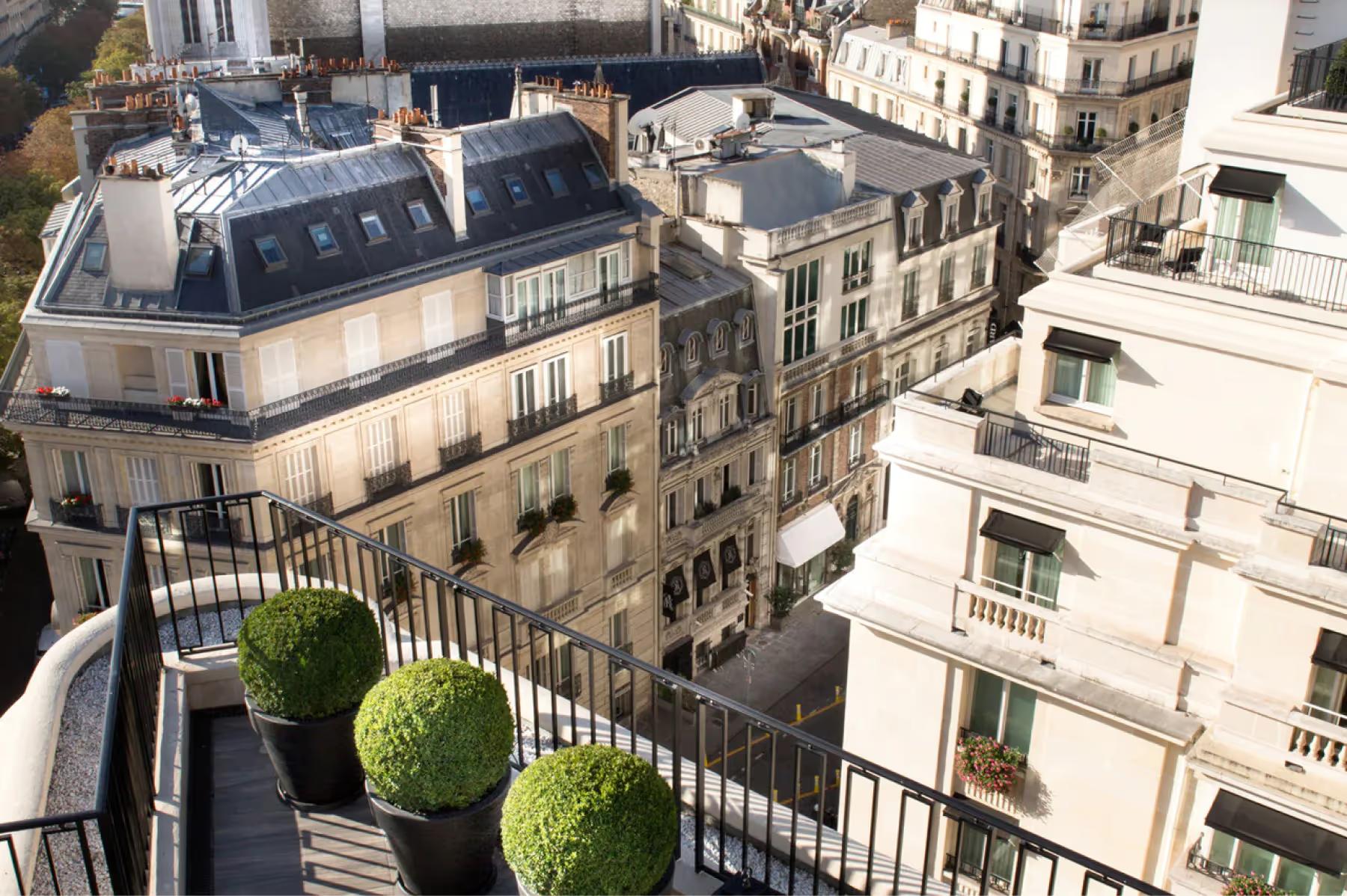 Four Seasons Hotel George V: a view from a balcony looking down at Haussmann building facades and the Seine