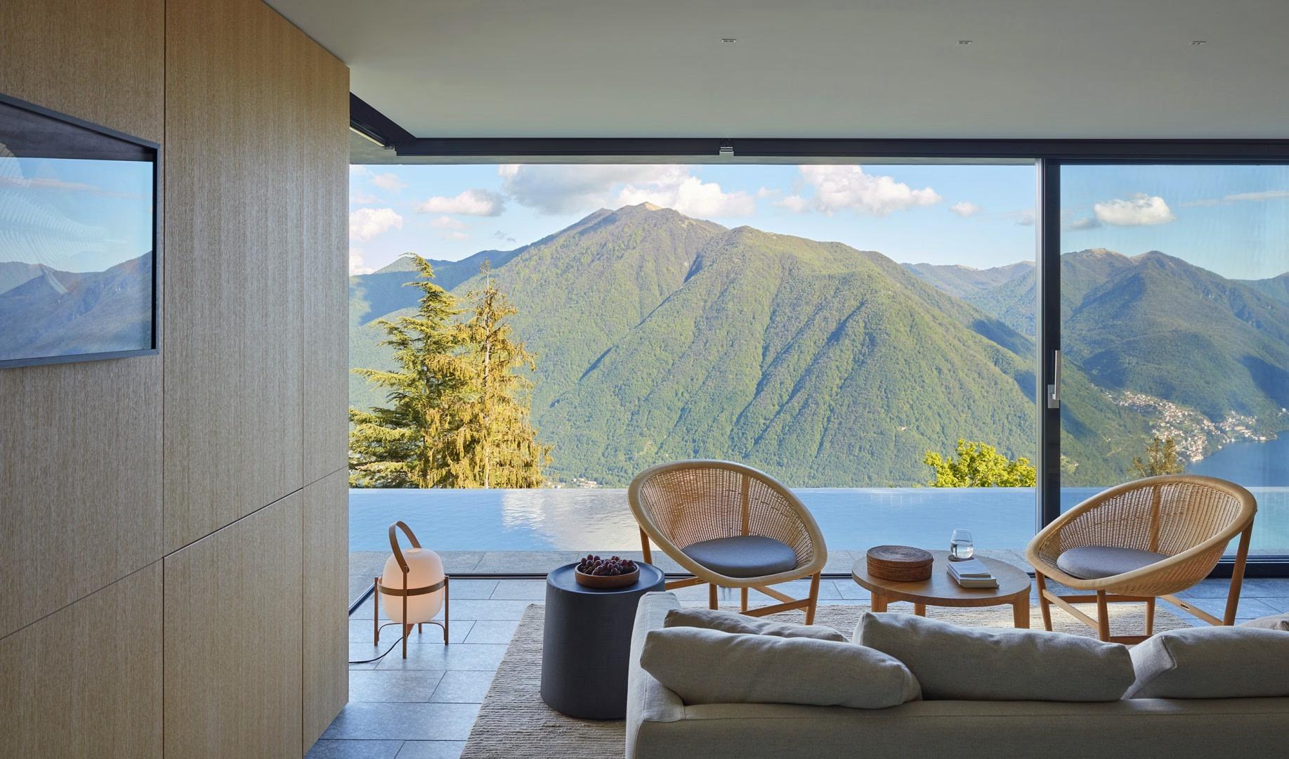 Villa Patrizia: a terrace with lounge chairs and lake views framed by modern architecture