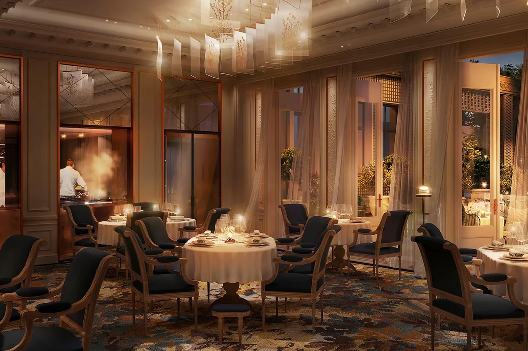 An upscale dining room with gold sconces, round table settings, and dark wood ceiling