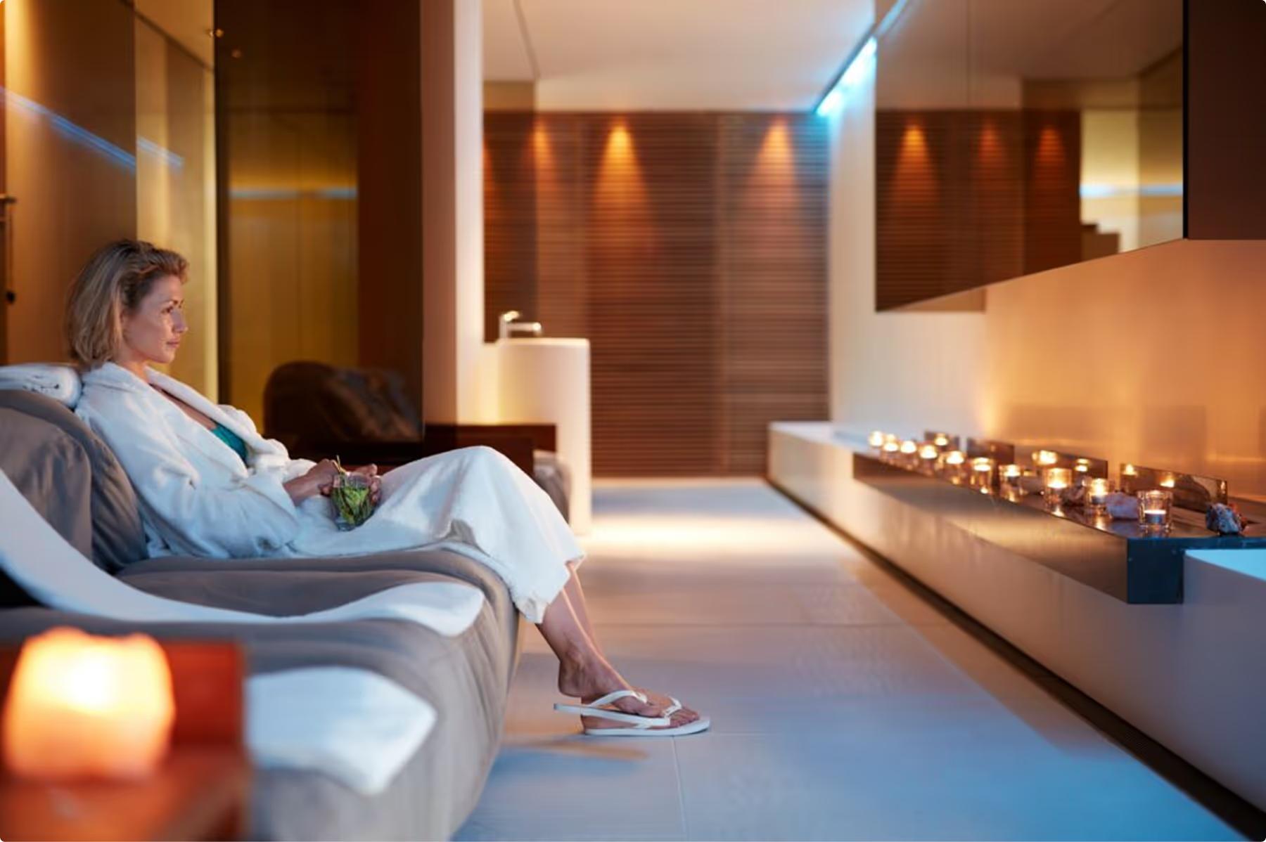 Mandarin Oriental Conservatorium, Amsterdam: wellness lounge with two lounge chairs, soft ambient lighting, and fireplace details