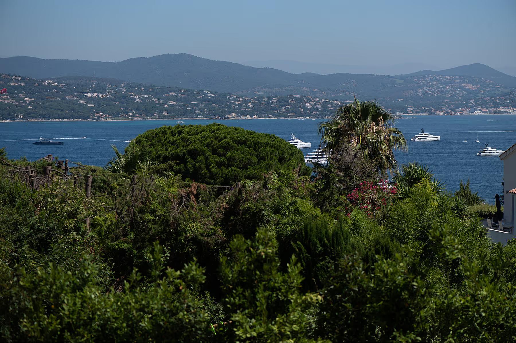 Althoff Villa Belrose: tree-framed view of the Mediterranean coastline from the gardens