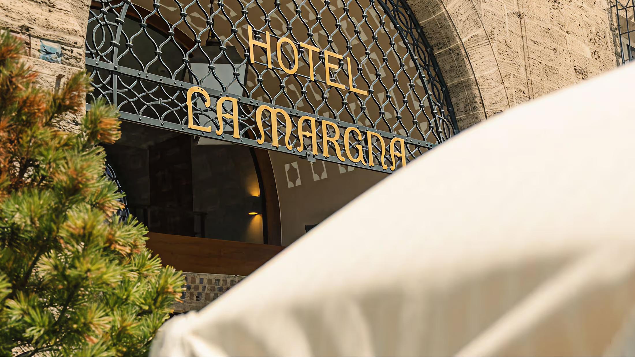 The arched entrance to Grace La Margna with the hotel name in gold lettering