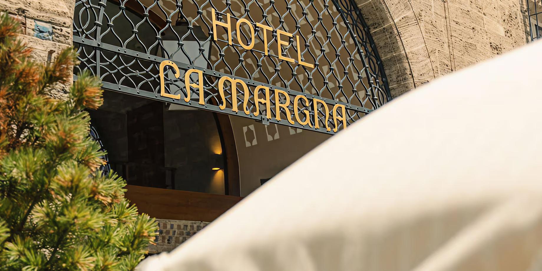 The arched entrance to Grace La Margna with the hotel name in gold lettering