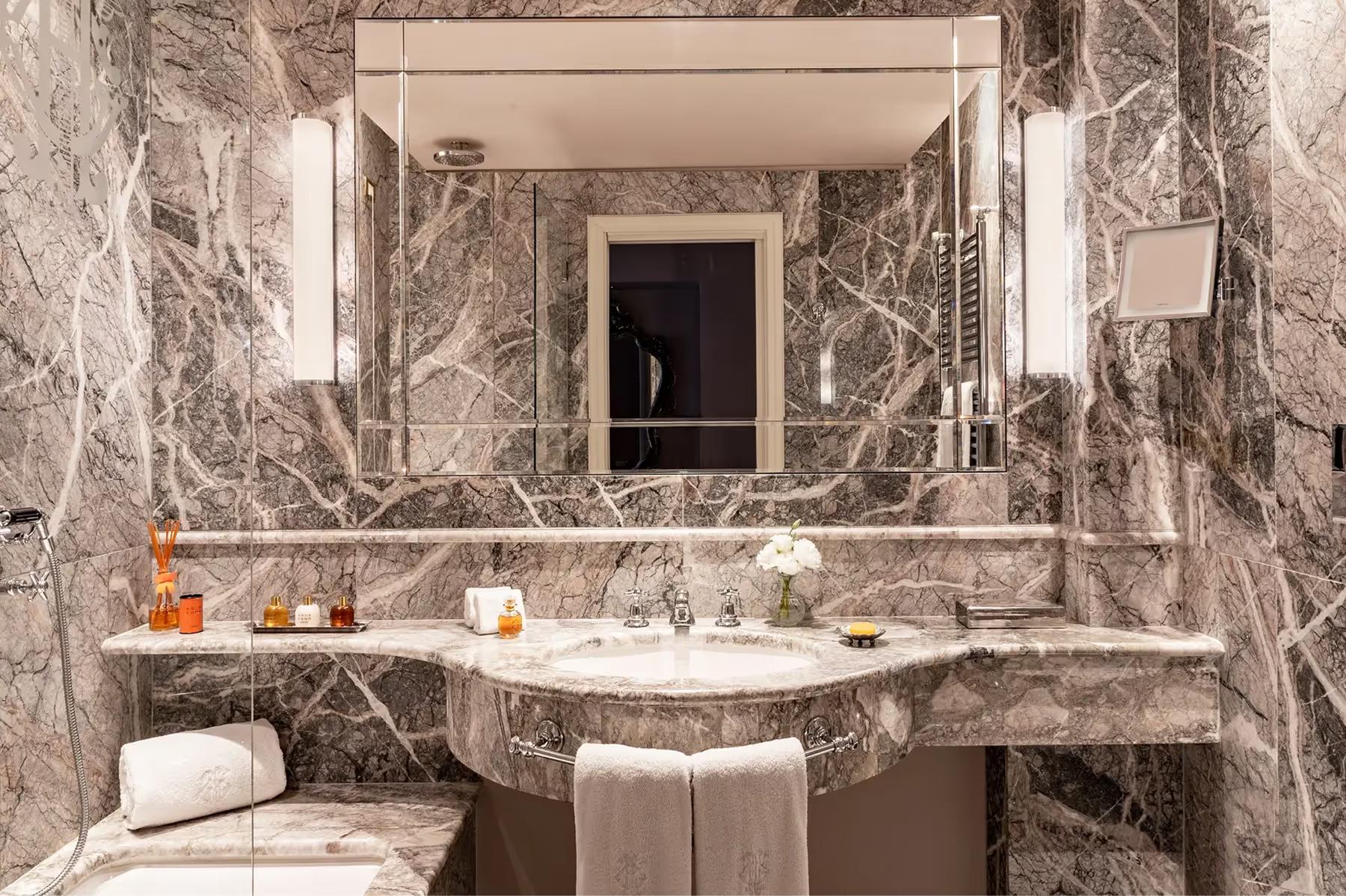 Luxe marble bathroom with double vanity and vessel sink basin